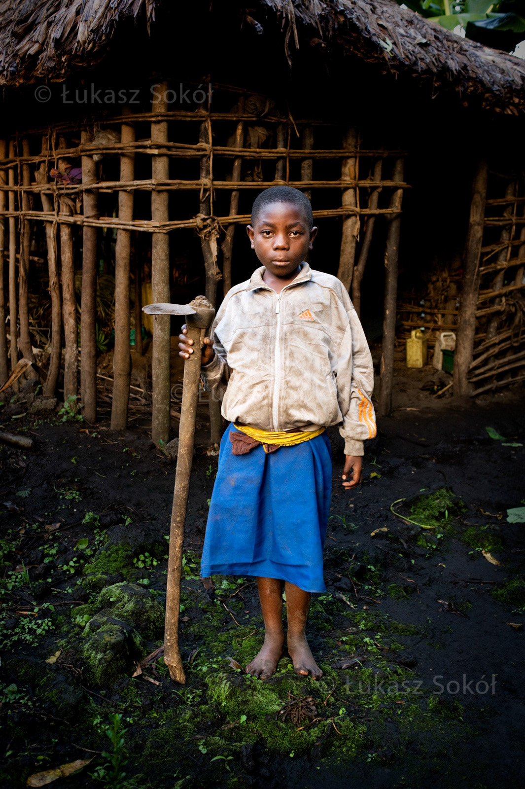Makoro Tuyishime, aged 8, a 2nd grade student of primary school. She lives with her mother and sister. In the evenings they move to their neighbours to spend the night safely. After school she grows beans and corn in a rented field. She bought the hoe on the market for $2, it allows her to cultivate the land and have food. She wants to become a nun or a teacher. Her dream is to have a new house and her own field. Ntamugenga, DR Congo, 2010