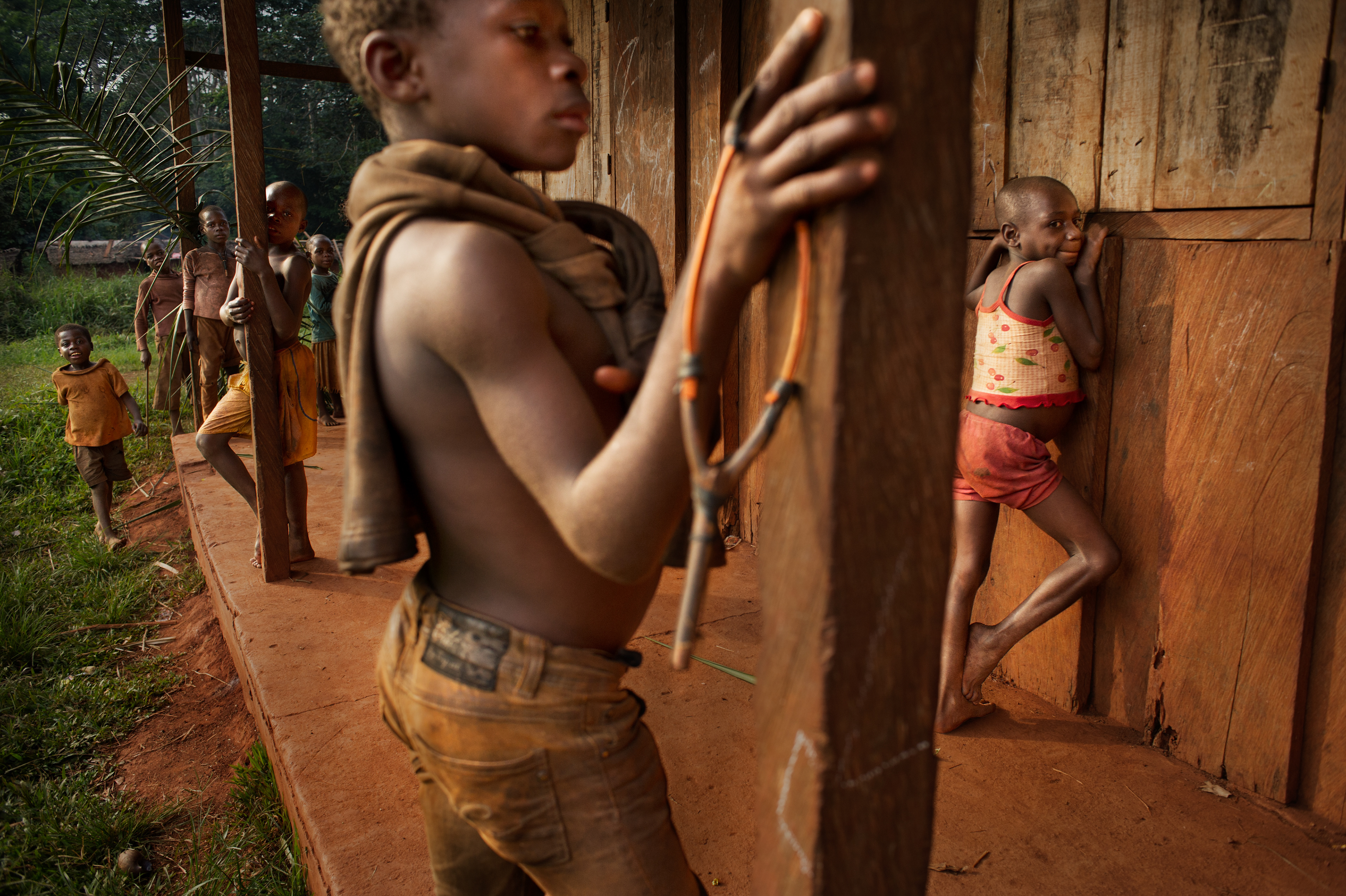 Children from the Abatwa tribe (called pygmies) in front of a school built with the help of missionaries from the Congregation of the Sisters of the Soul of Christ the Lord, in the village of Kolembok. Cameroon 2012