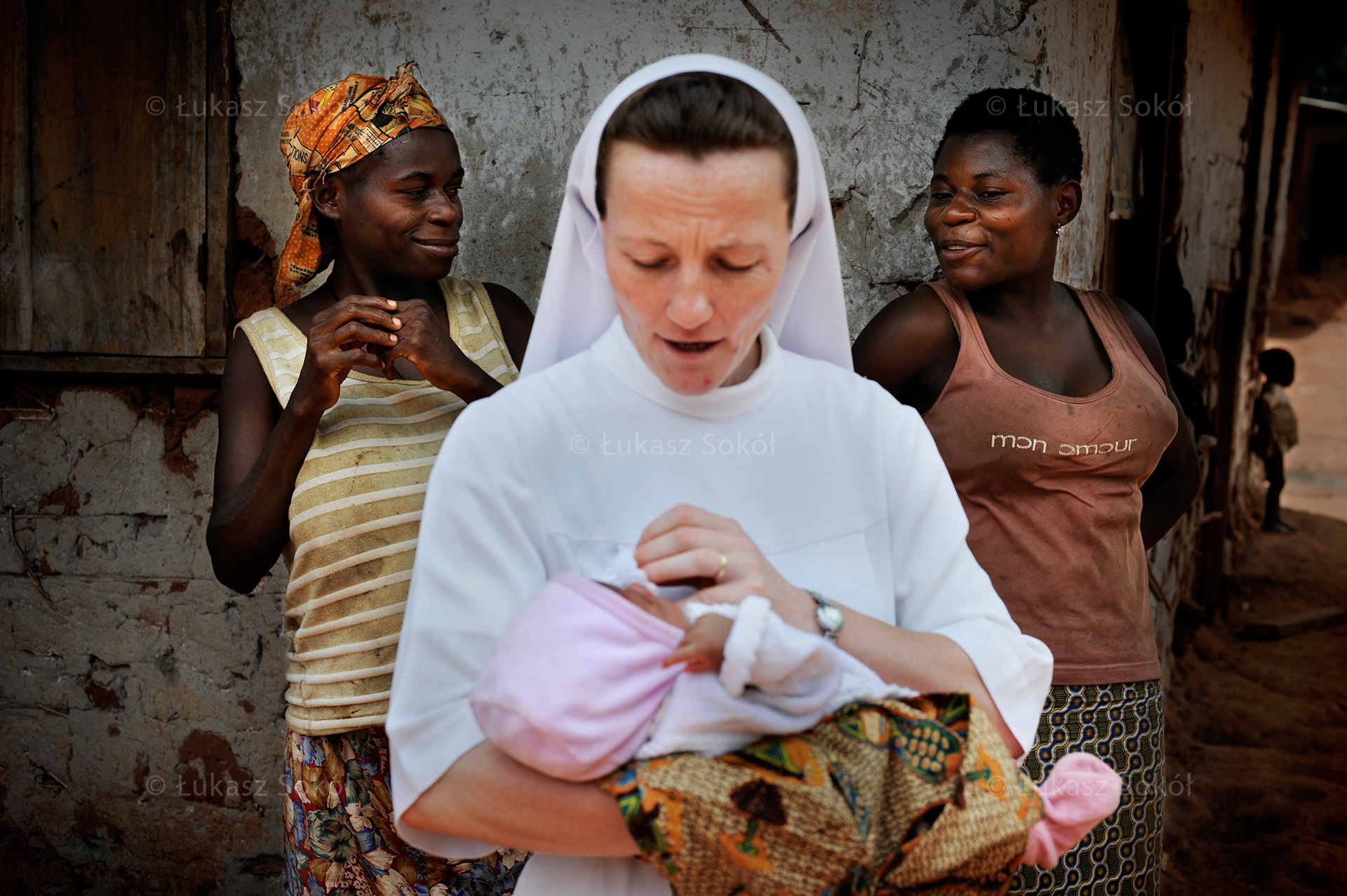Sister Regina from the Congregation of Sisters of Divine Providence during her visit in Essiengbot in Cameroon. She is there to see a new-born baby, the youngest villager.  Essiengbot, Cameroon, 2009
