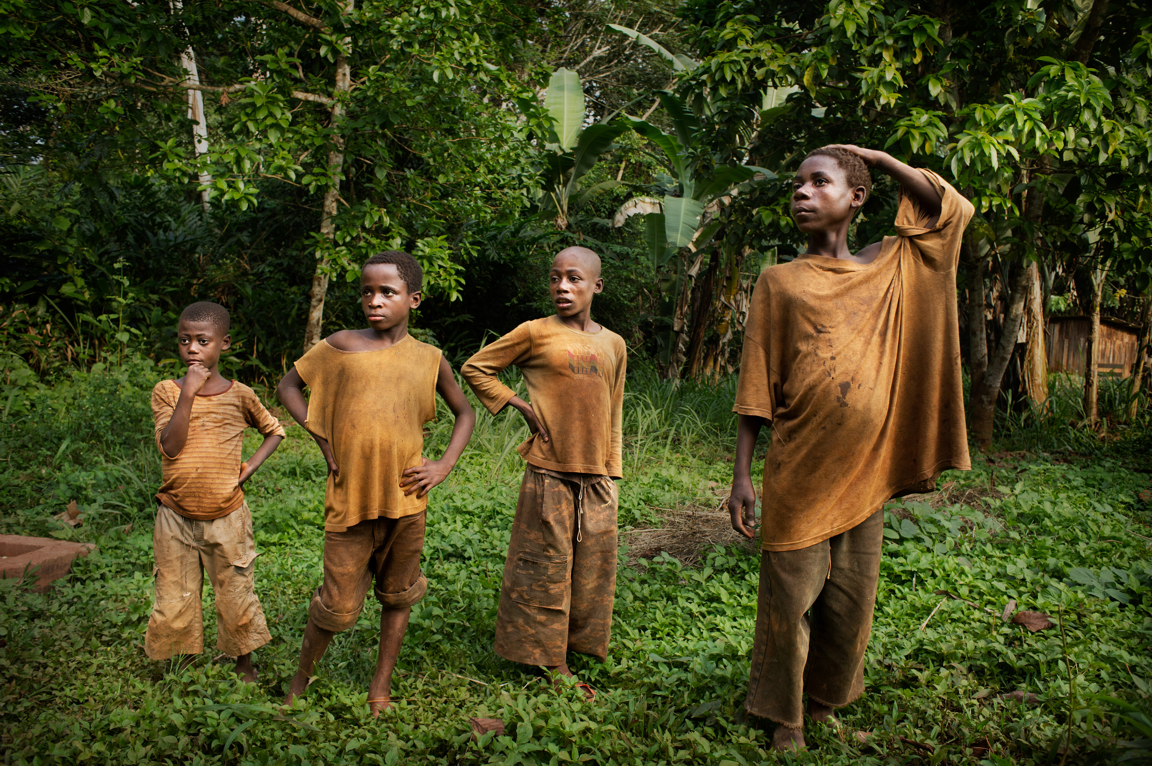 Children from the Abatwa tribe (called pygmies) in the village of Kolembok in Cameroon. The pygmies live in very difficult and primitive conditions here. Unfairly perceived by most Cameroonians as the margins of society. They have their own distinct culture, pride and value system. For generations, as a tribe of gatherers, they have peacefully moved through the forests in search of food. A sedentary lifestyle is incompatible with their nature. They cannot move. The criminal deforestation of their region has scared away most of the animals and destroyed the natural order.  Cameroon 2012