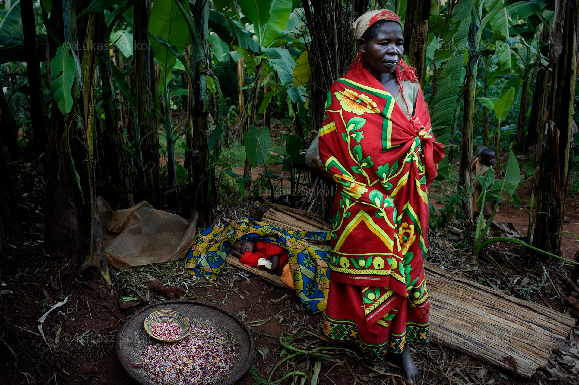 A mother with a child ill with malaria in front of her house in the village of Buraniro. Burundi is one of the poorest countries in the world. Buraniro, Burundi, 2010