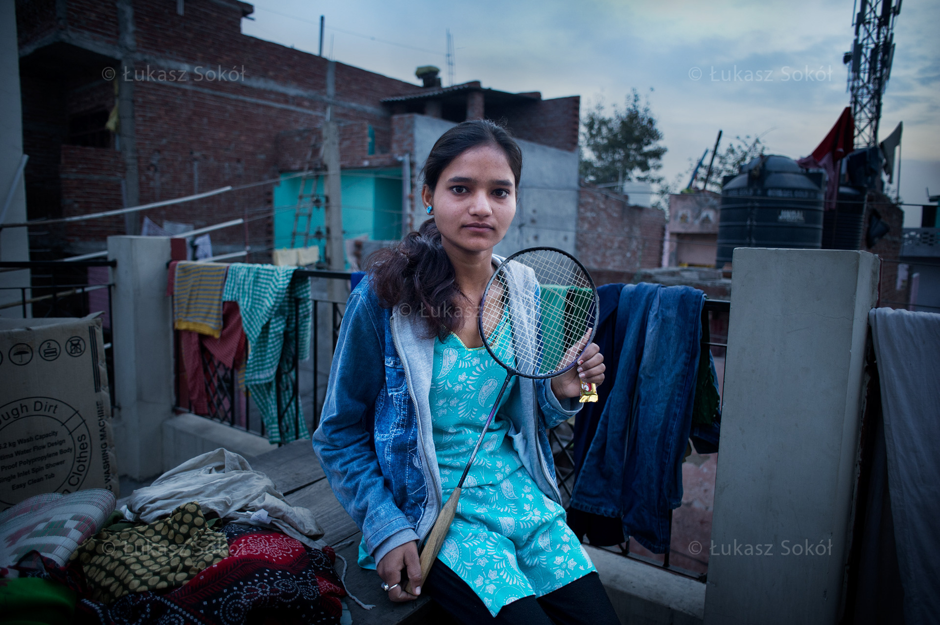 Priyanka, 17 years old. She has got two brothers. She bought the rocket for INR15 (0,30 USD / 0,22 EURO) at the market. She plays badminton in her free time. She is a pupil of 11th grade. She attends after-school activities. At home she cooks, cleans in the morning and in the evening. She dreams of becoming a fine dancer. New Delhi, India, 2012
