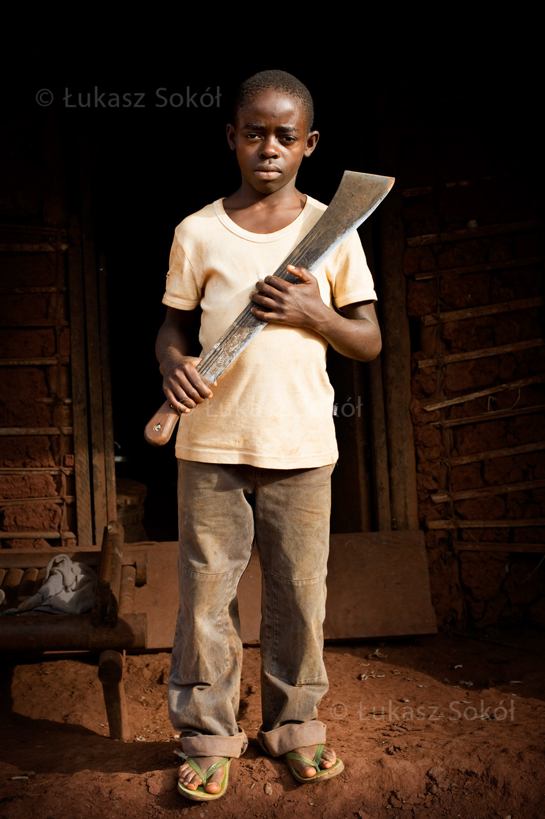 Sophonie Mingous, aged 11, 6 siblings, they live with their parents. After school he cuts the grass with his machete around the house an on the coffee field. He wants to be a priest, he dreams of working. Ouama, Cameroon, 2009