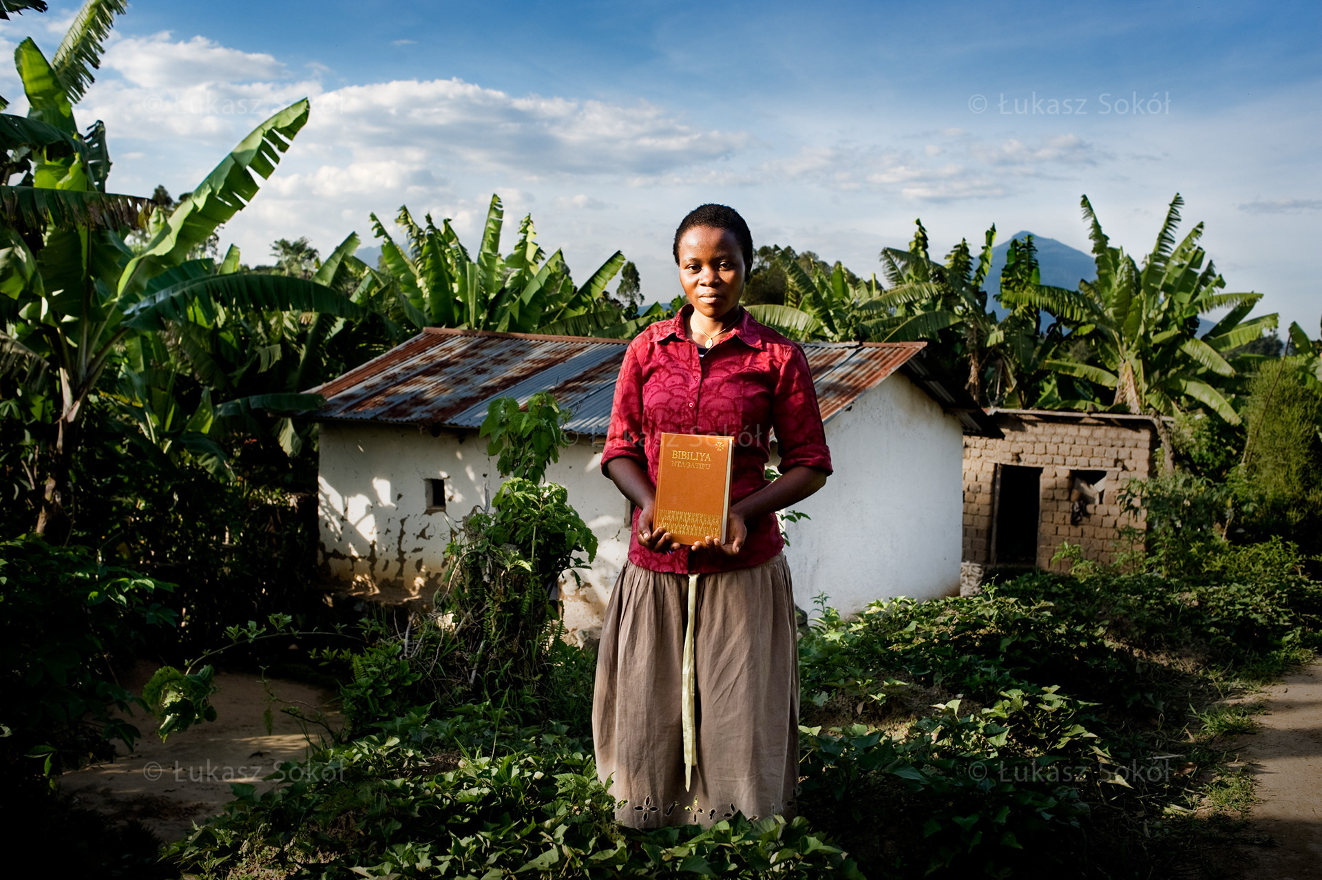 Claudette Umutoni, aged 17, in the 2nd year of secondary school. She does not have parents, she lives with her aunt and her 12-year old son. Every day she gets up at 5 a.m. and falls asleep at 7 p.m. (an hour after the sunset). After school she helps with land cultivation (beans), she cooks (usually sweet potatoes) and in the morning she goes to church to pray. She won the Bible at a lottery organized every year around Christmas. It is the most important to her, because it helps her to know the Word of God and pray. She wants to be a doctor. She dreams that someone will help her study at school as she still lacks some money for the school fee. Nyakinama, Rwanda, 2010