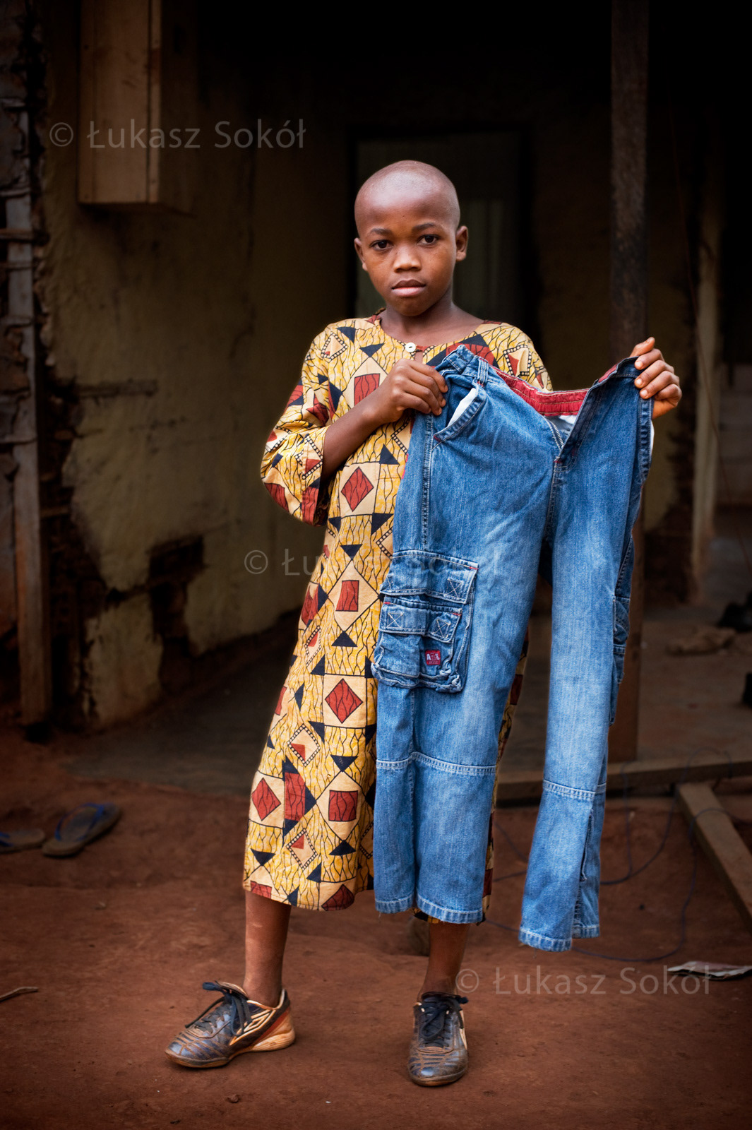 Milang Sergie Brondon, aged 10, he has 3 sisters and a brother. After school he helps his mother to prepare food and then he plays football. He wants to be a policeman. He got the trousers from his mother, that’s why he likes them so much. Abong-Mbang, Cameroon, 2009