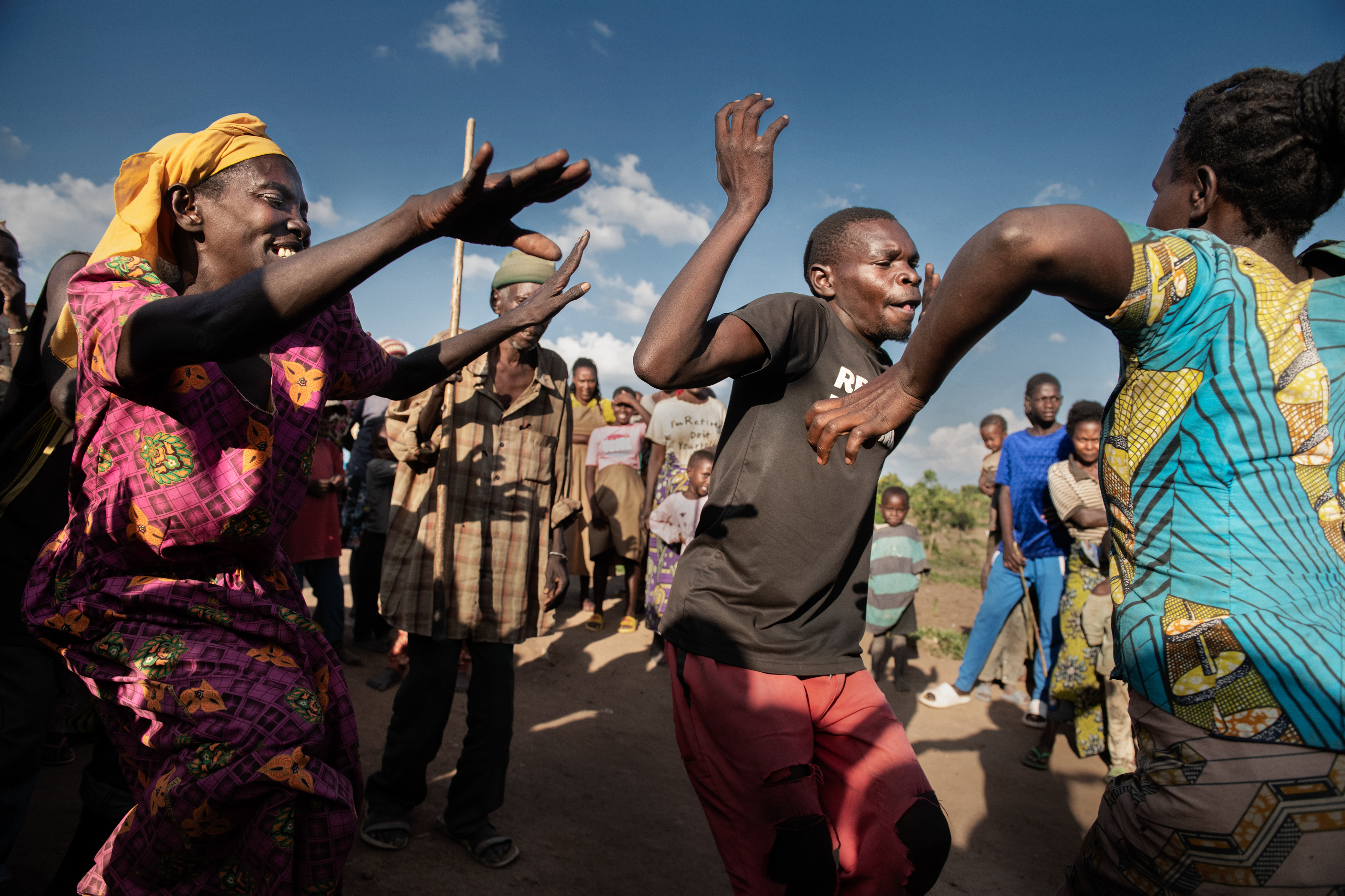 The outskirts of Ruhango village in Rwanda. The Abatwa tribe (called pygmies) have been forced into a sedentary lifestyle. They live in poverty, barely surviving on selling the clay pots they make and celebrating local celebrations with dance. No one else performs the "cow dance" (the national dance of Rwanda) like them. They find help in the nearby mission of the Pallottine Sisters. Although they live on the sidelines, unnoticed and disrespected, their dance arouses true admiration from other tribes. Rwanda 2022