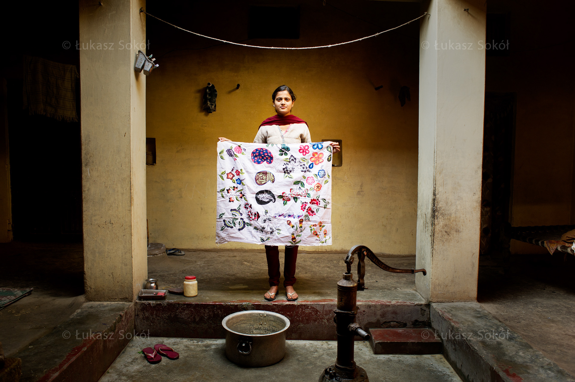 Jaya, 16 years old. She has 2 sisters and 2 brothers. Painting is her hobby. She bought the fabric for a table cloth and painted it on her own. She doesn't sell her work but sometimes gives it as a present. After school she cooks and cleans, walks and meets her friends. When she grows up she wants to be an art teacher. Khalilabad, India, 2012