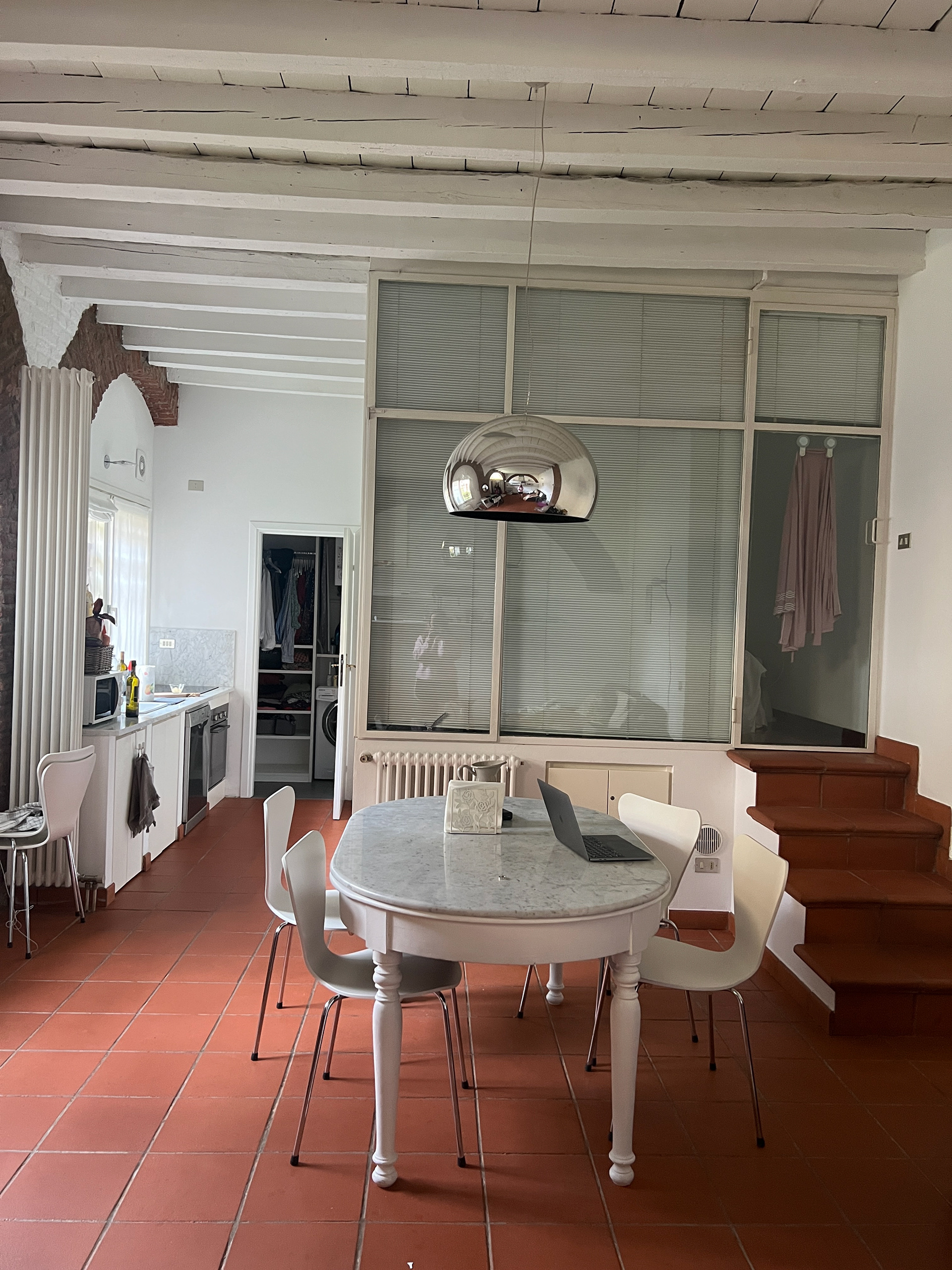 Our dining room. The stairs on the right lead up to our bedroom and our kitchen is on the left