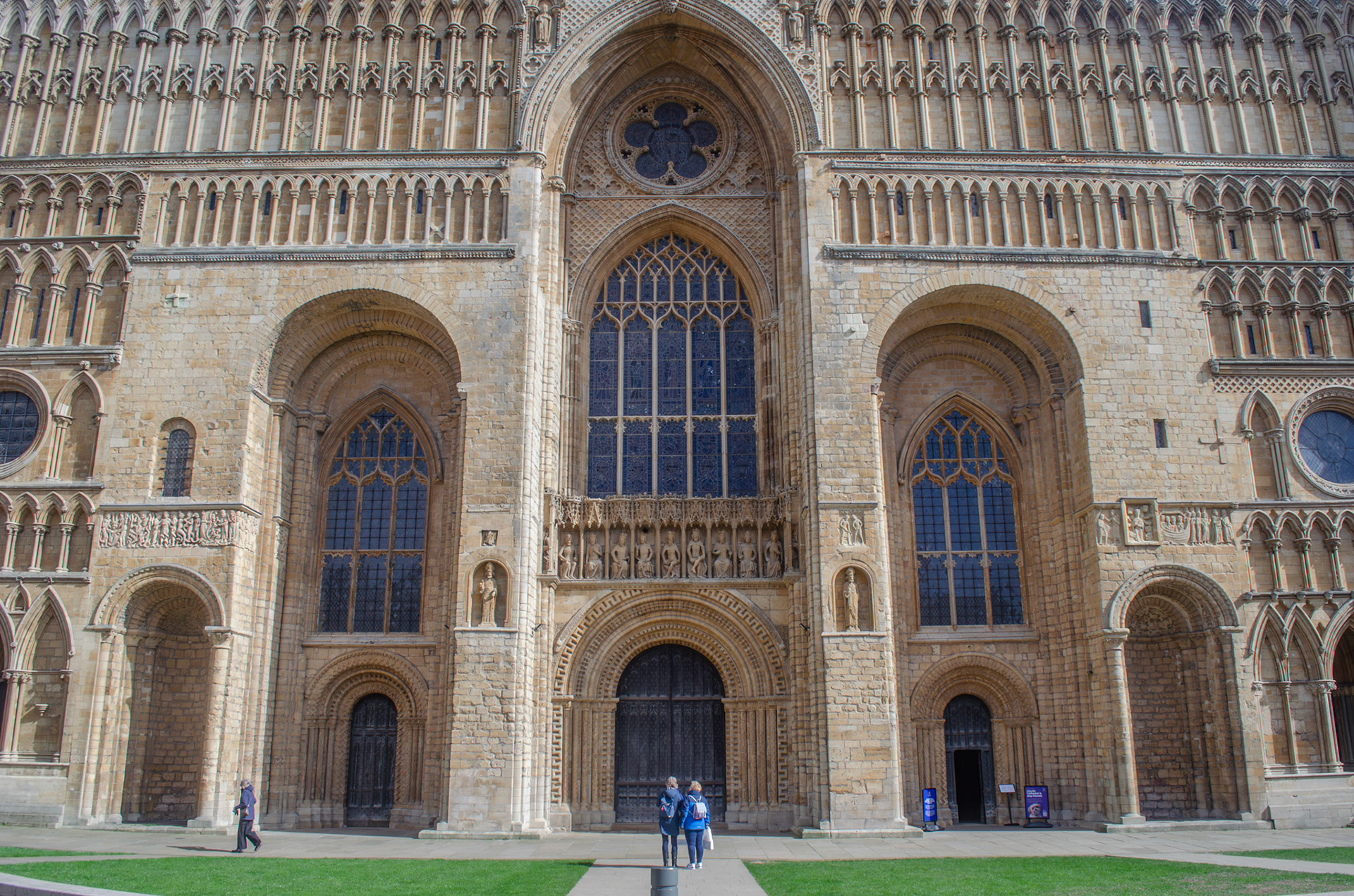 Two travellers stare up at the grand Lincoln Cathedral