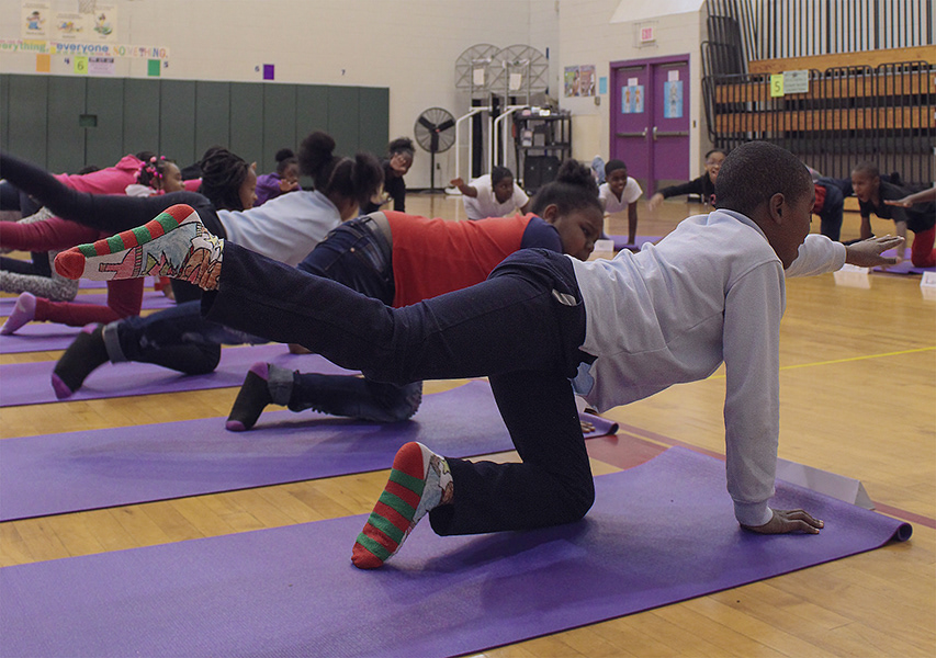 Students in "Balancing the Cat" pose.