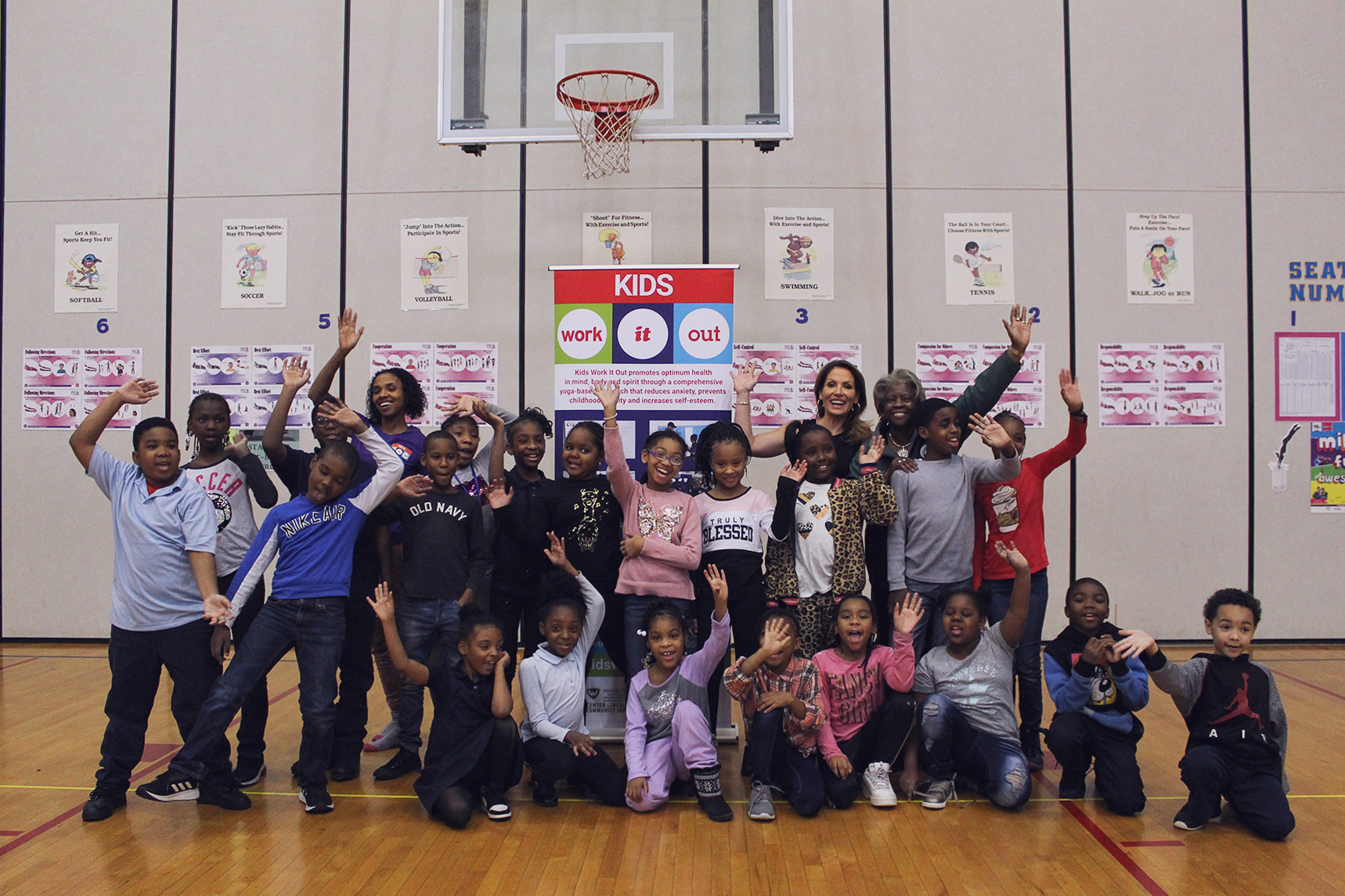 A group photo with Danialle Karmanos, Adrienne, Ms. Stahl (PE teacher), and our little yogis!