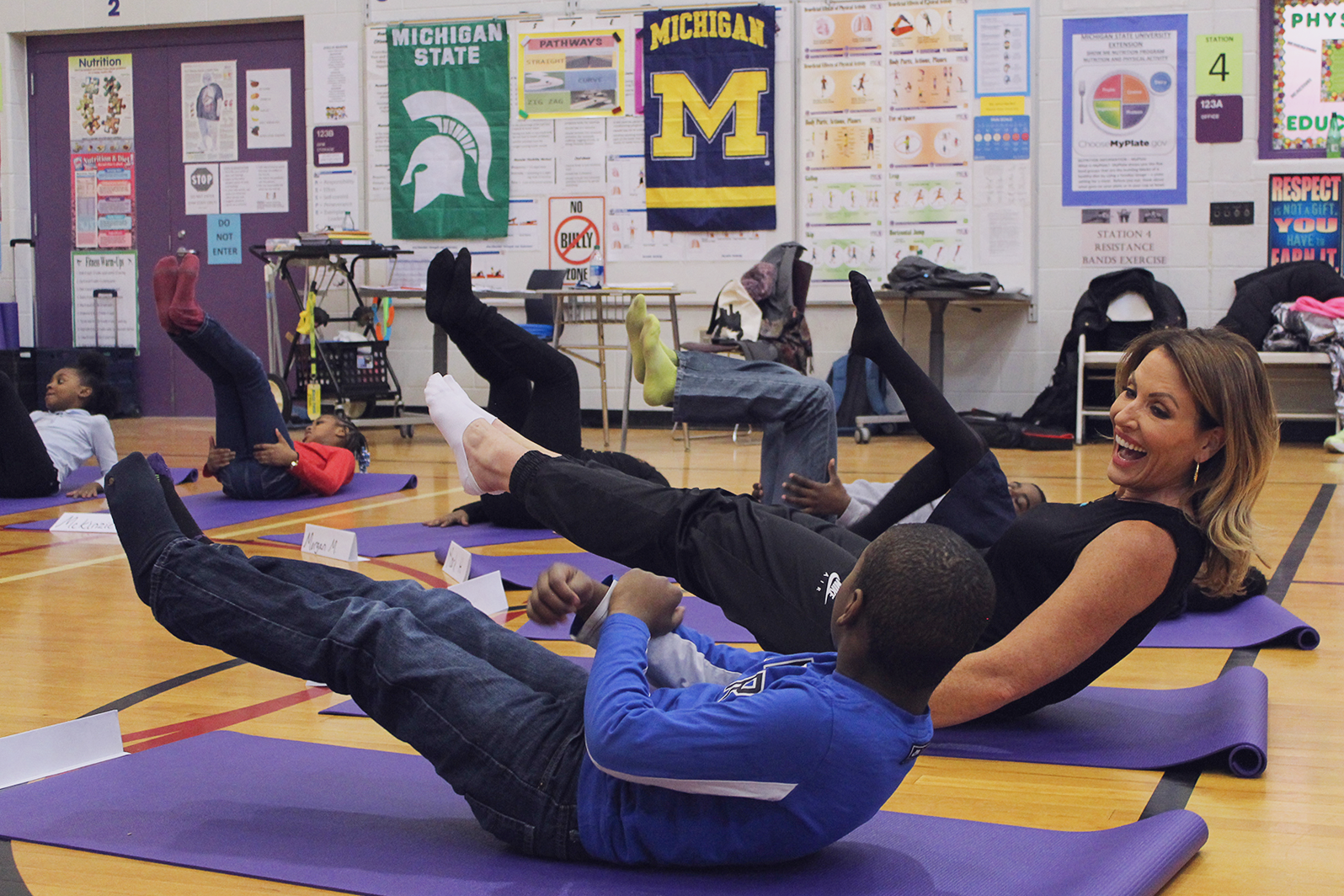 Danialle Karmanos and a student in "Boat" pose.