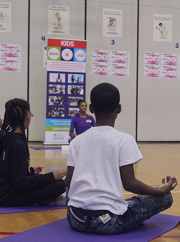 Students starting yoga class in "Easy Pose".