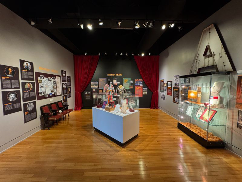 Photo of gallery space with text panels and artifacts on display