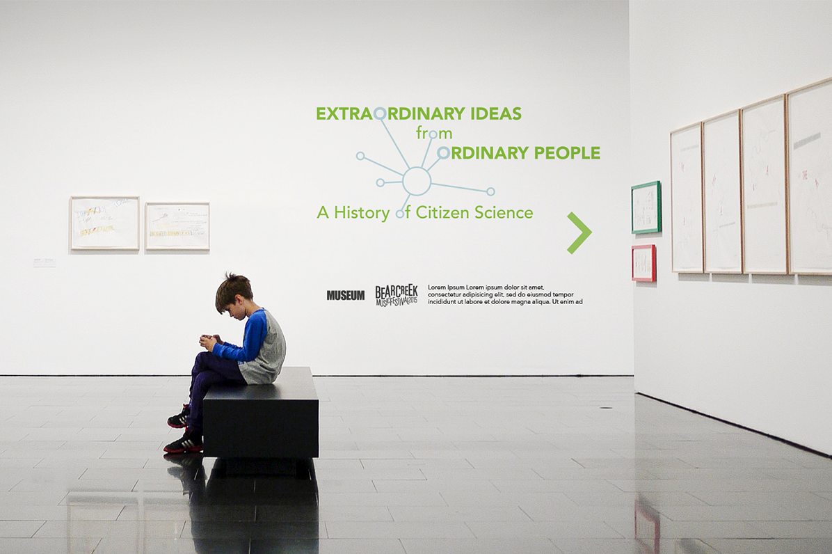 A gallery space with white walls and a young visitor sitting in the center. The project’s title design is seen on a far back wall.