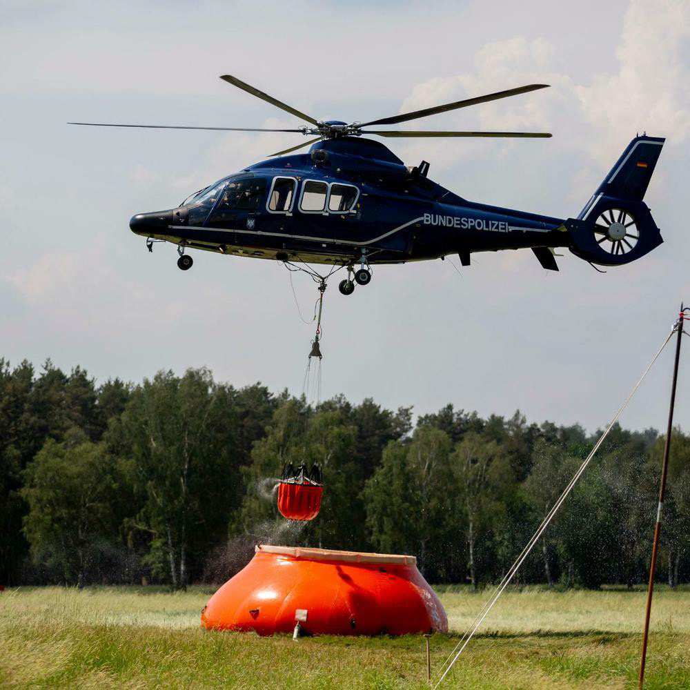 Transport helicopter of Bundespolizei Refills its Bambi Bucket in a Pumpkin (Water pool)