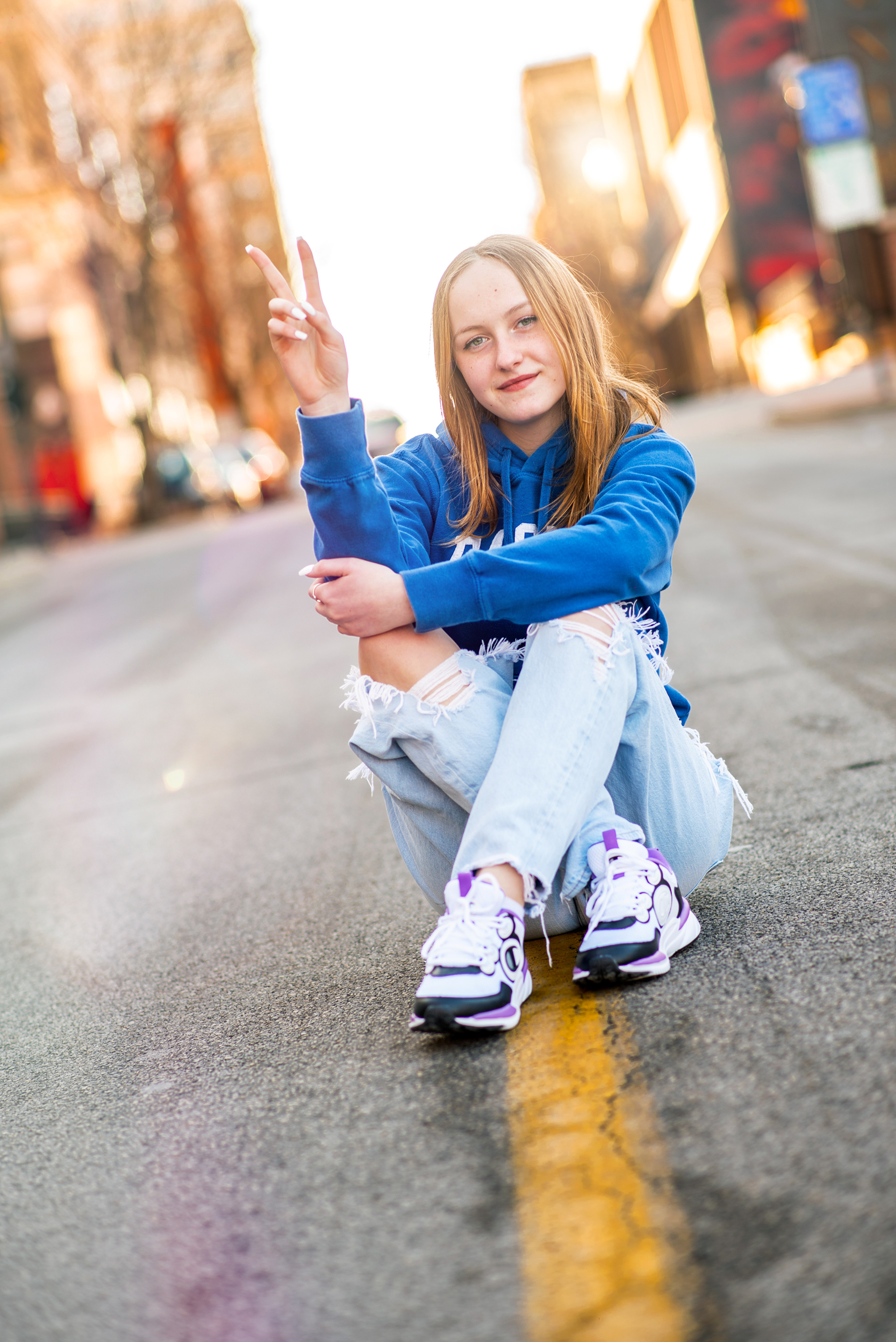 Urban stylHigh school graduation portrait photographer serving St. Joseph and Kansas City. Professional 85mm lens technique for high-end bokeh and authentic expressions in every portrait.e senior portrait session for high school graduates in Kansas City. Creative outdoor photography using natural light and professional posing in downtown environments.