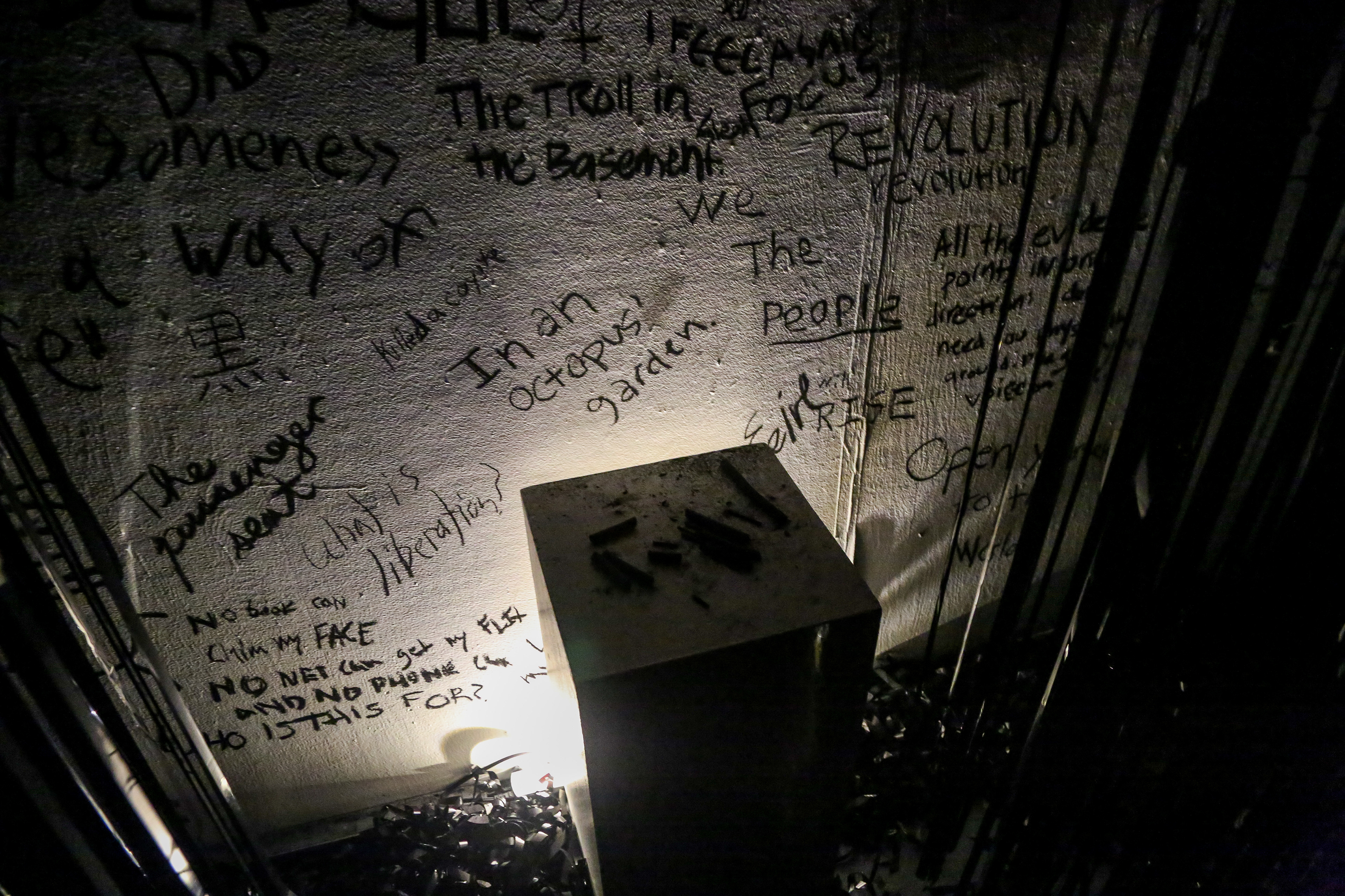 RECORD (WRITE): Use charcoal to write an inscription on the wall with charcoal