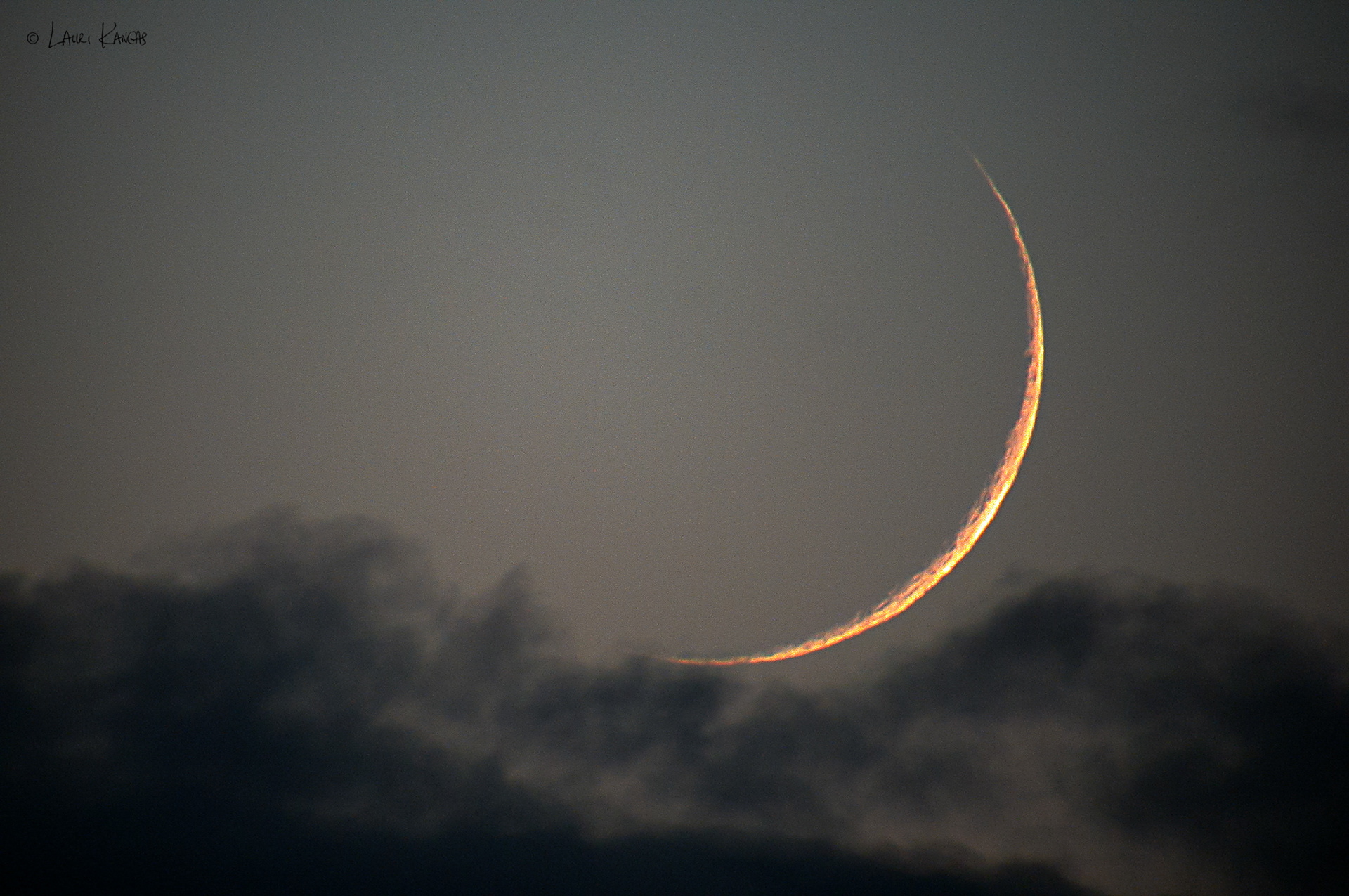 Thin Crescent Moon in the Clouds