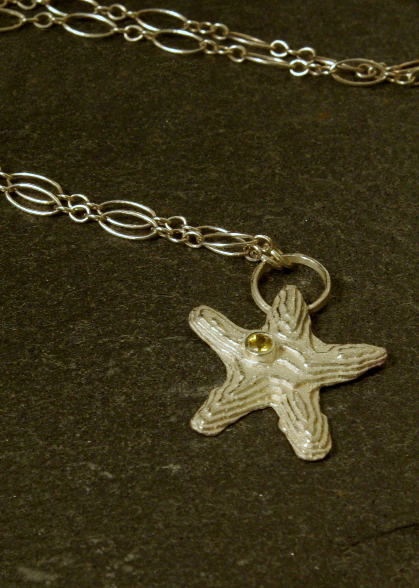 starfish pendant, cuttlebone cast sterling silver, yellow sapphire