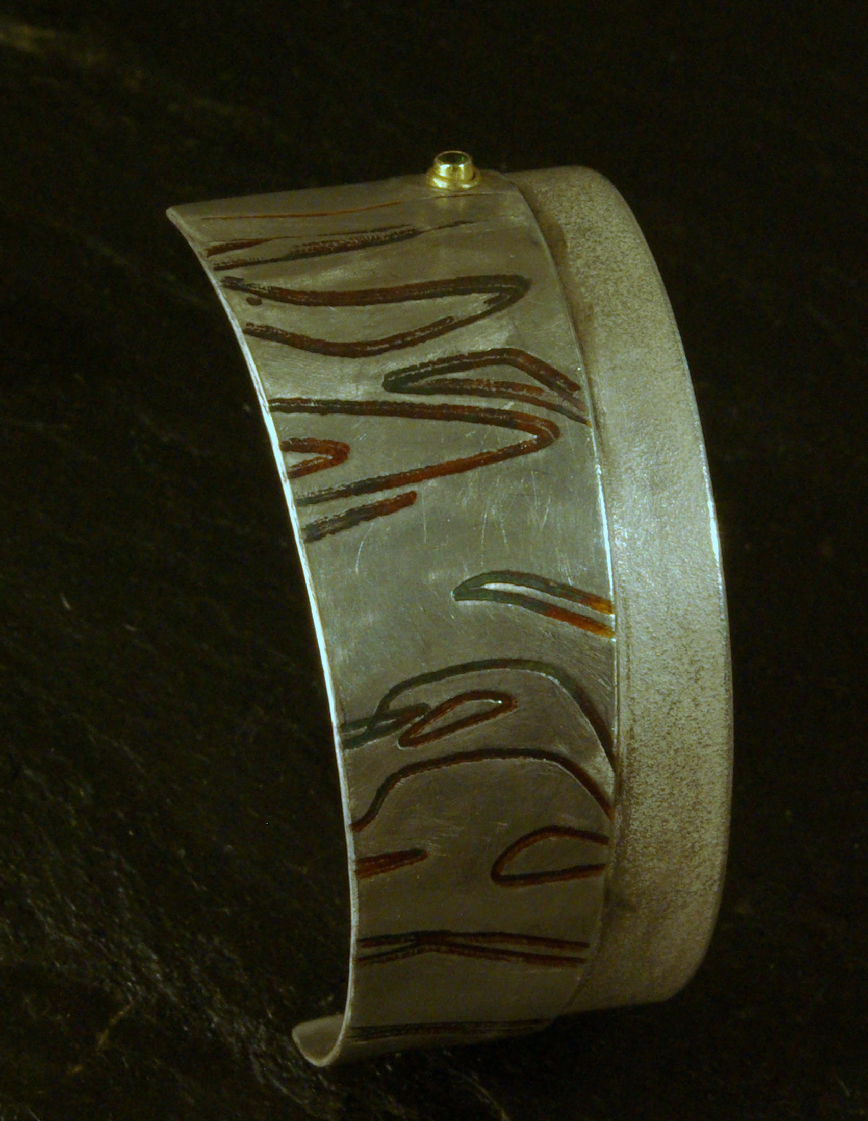 tigre cuff, sterling silver, green sapphire in 14Ky gold / overlay rolled from photo etched brass, oxidized