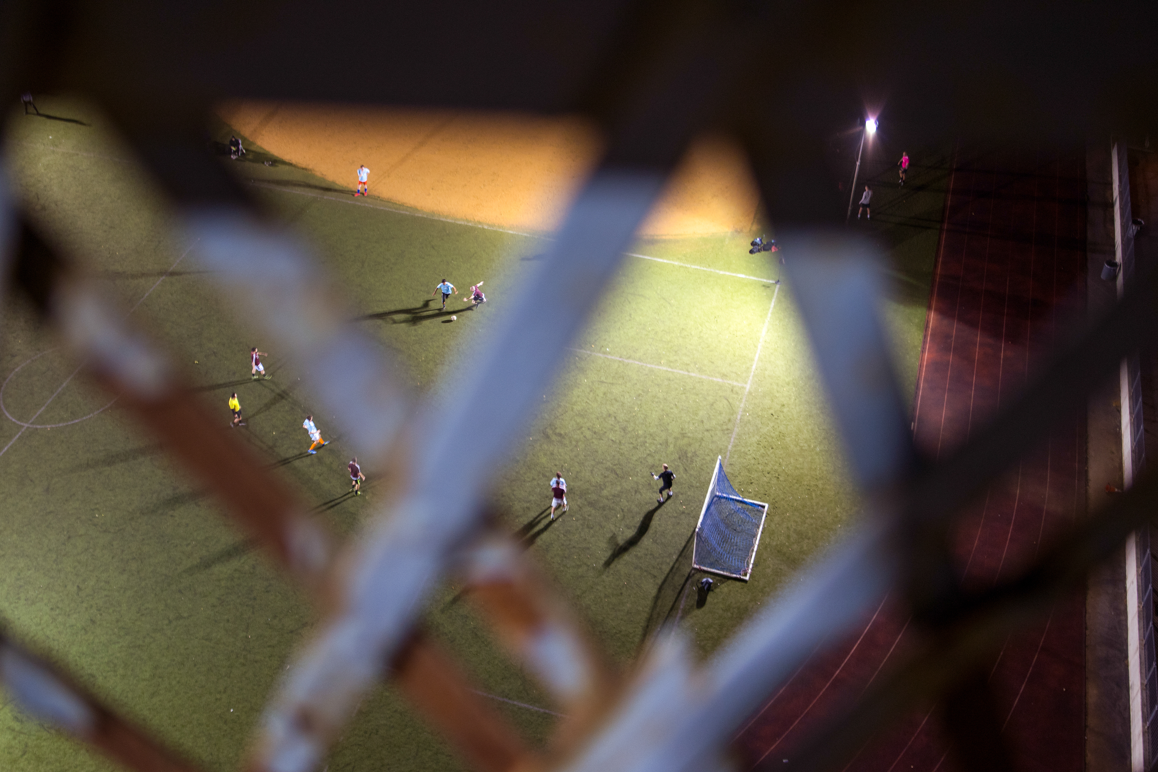 Men play Soccer below the Manhattan Bridge near Chinatown NYC