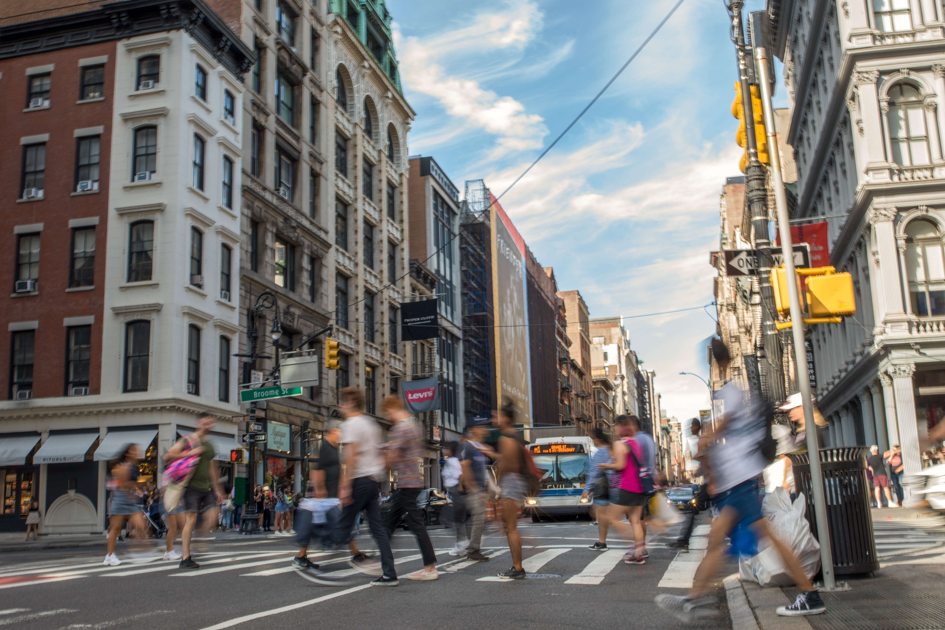 People crossing the street in blurred motion in SoHo, NYC