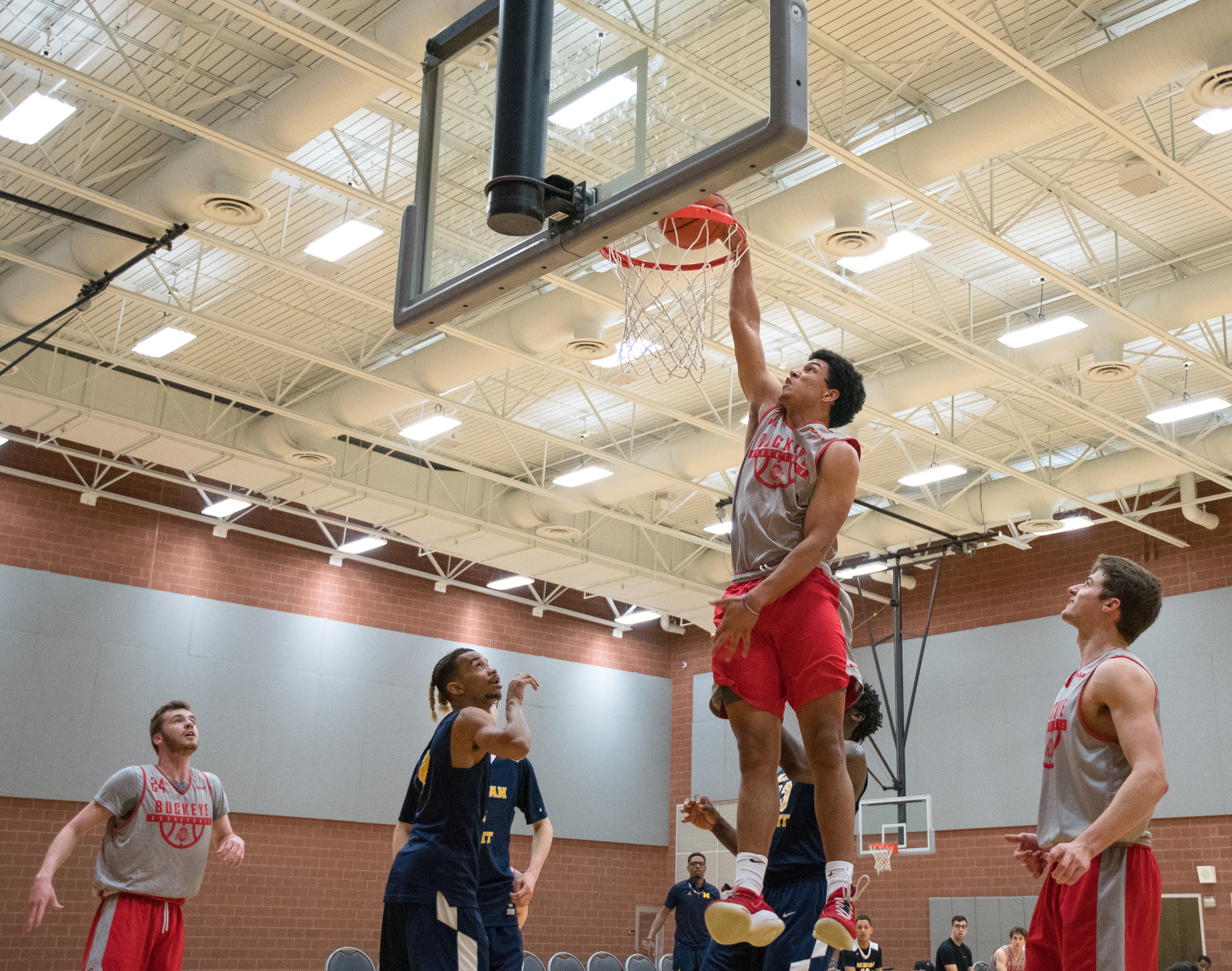 A member of Ohio State's Junior Varsity basketball team dunks the basketball vs. University of Michigan - Flint