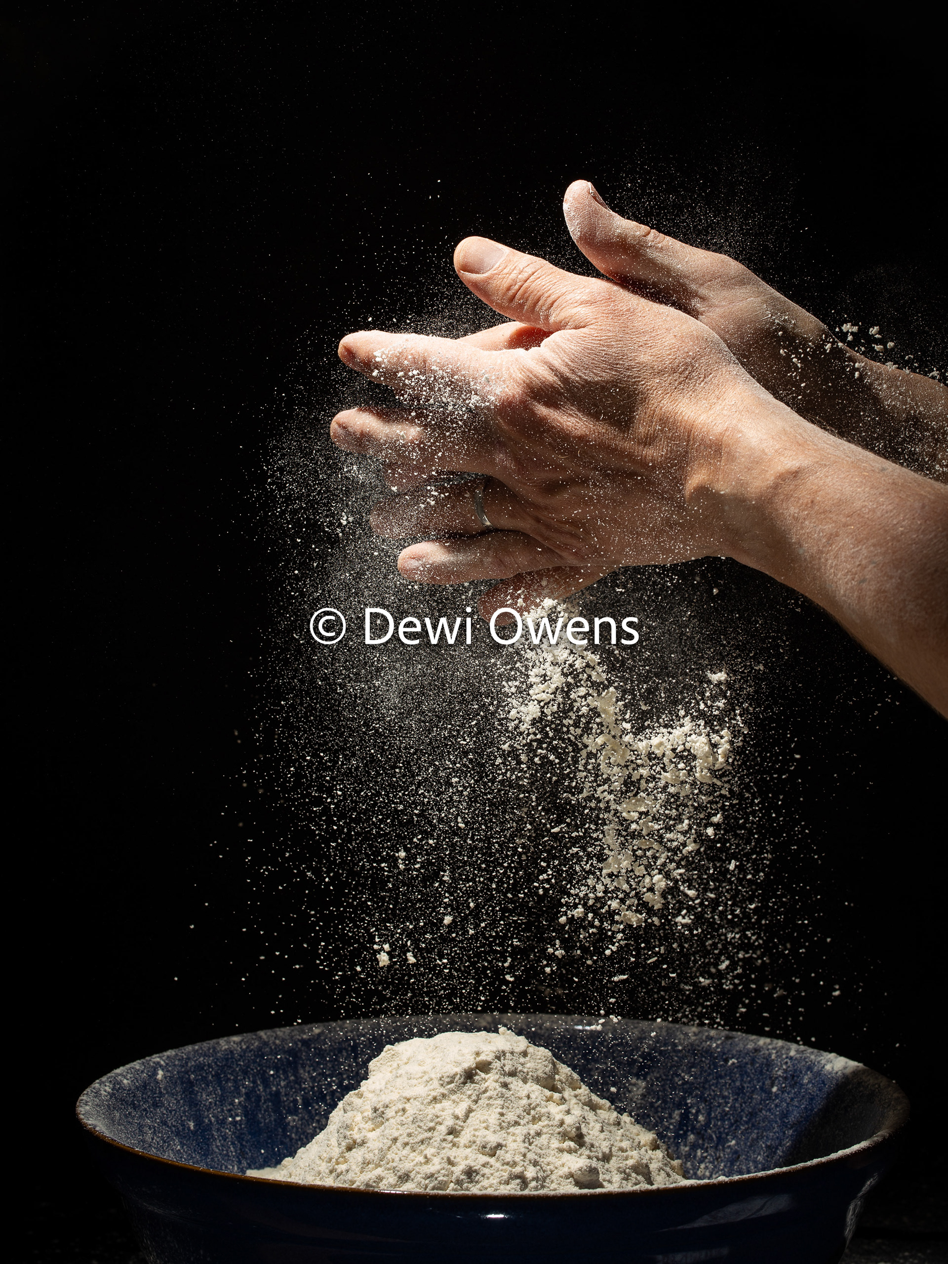 Baker's hands working with flour