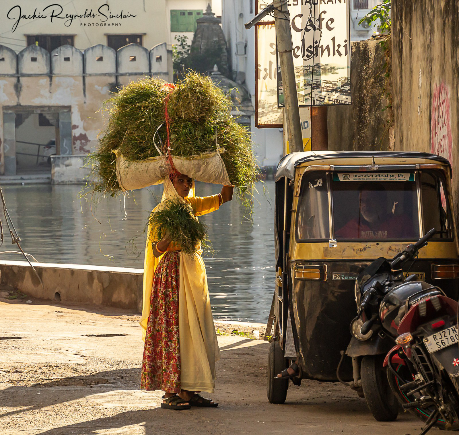 Lady chatting with a Tuk Tuk driver beside Lake Pichola, Udaipur