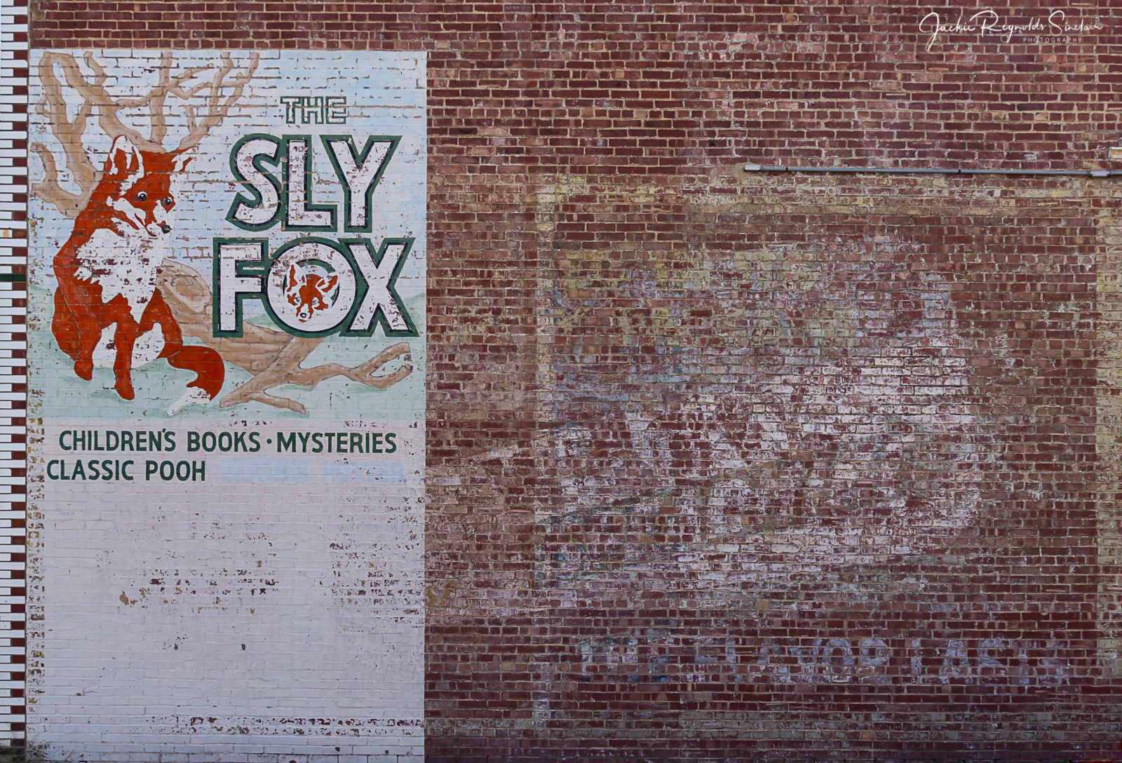 An EMBARRASSMENT of ghost sign riches on a single wall in Virden, Illinois! I am not sure how old the Sly Fox sign is, though it’s clearly of more recent vintage than the Wrigley’s and the millinery.