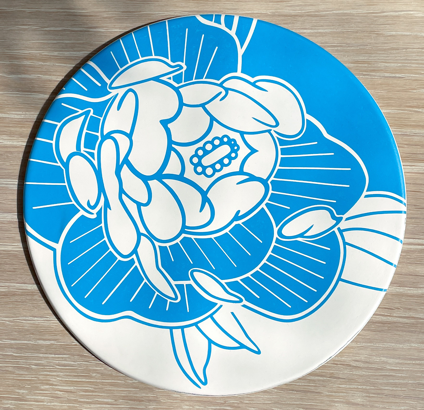 Porcelain tile with blue vinyl stencil ready to be glazed