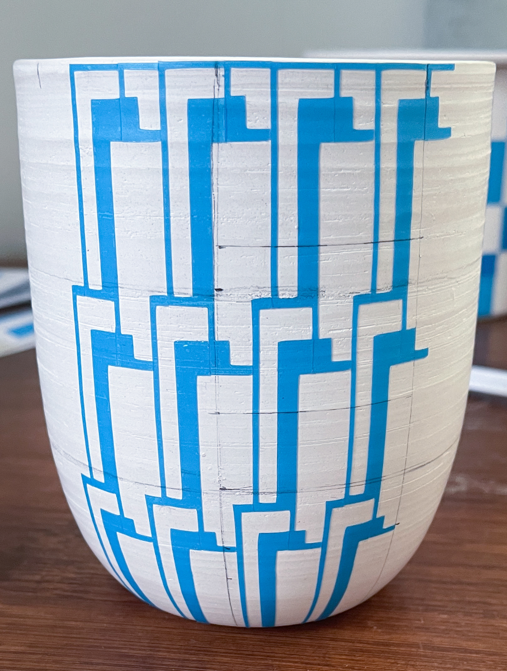 Vinyl being put onto a porcelain cup before glazing