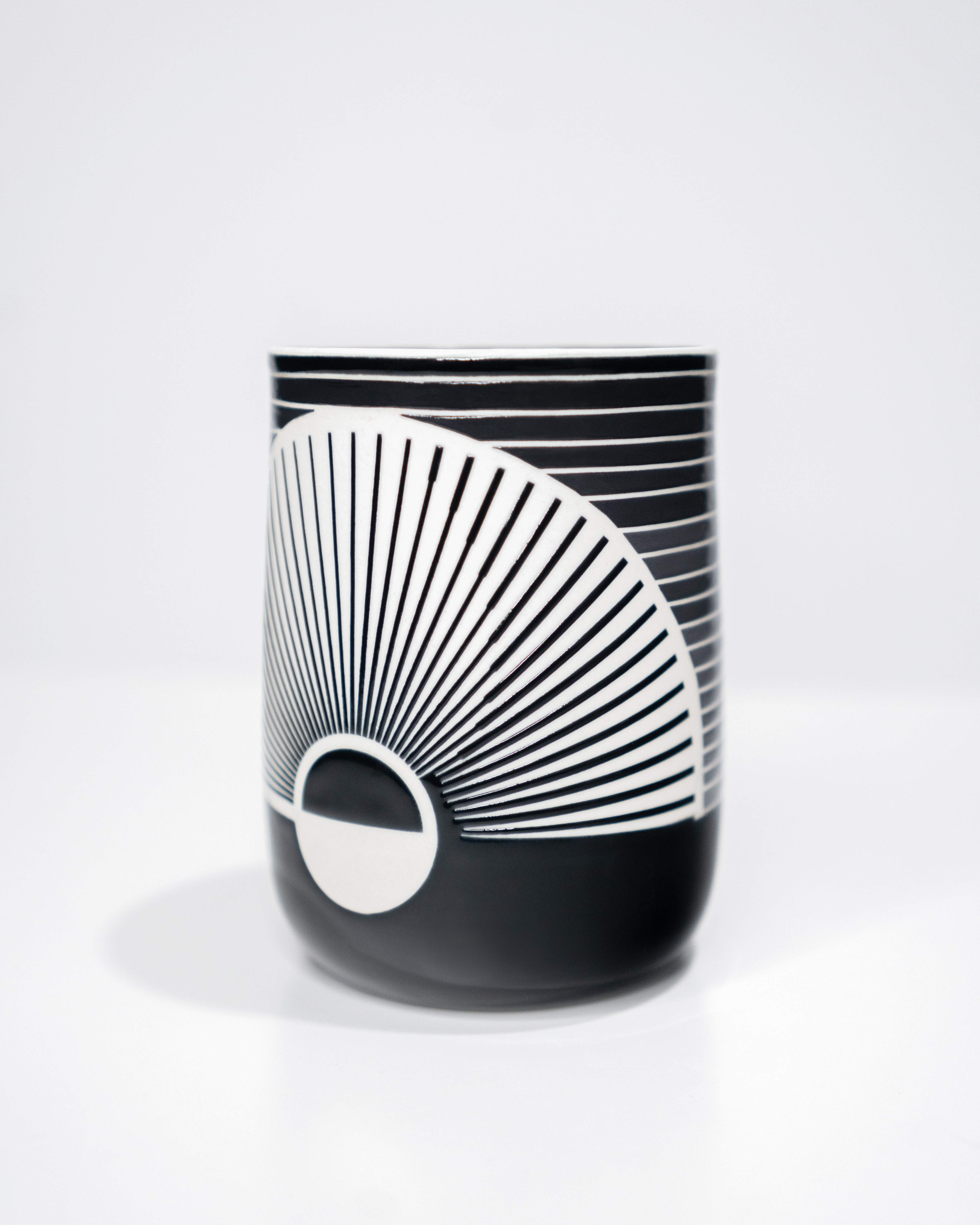 2023. Wheel thrown porcelain with geometric patterns designed digitally and glazed using vinyl resist