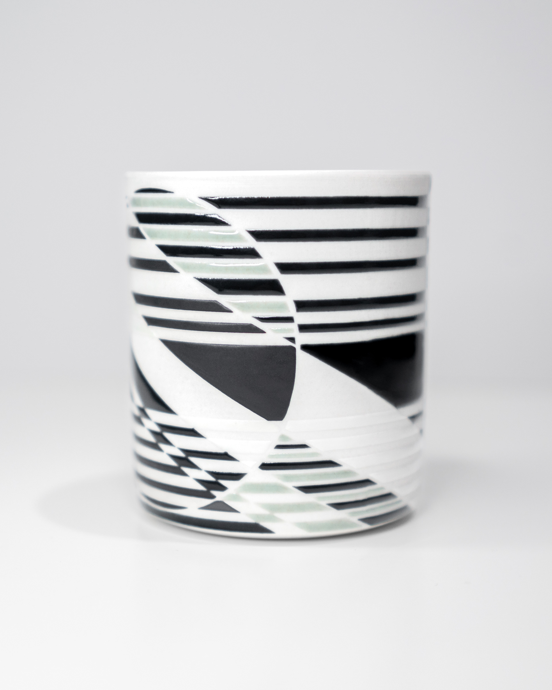 2024. Wheel thrown porcelain with geometric patterns designed digitally and glazed using vinyl resist
