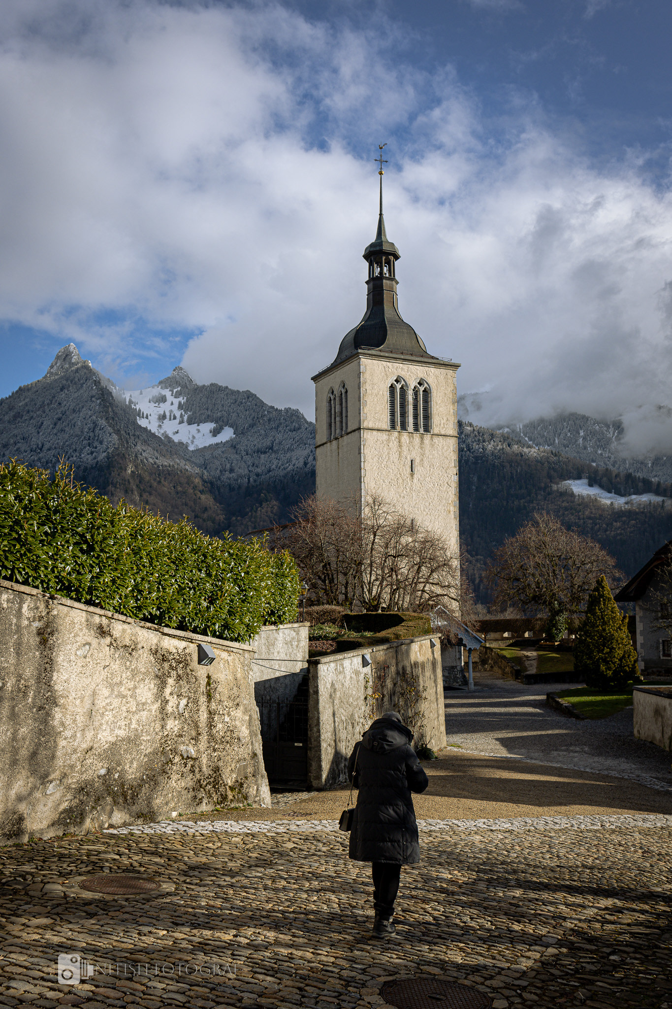 A timeless church standing tall against a dramatic alpine backdrop.