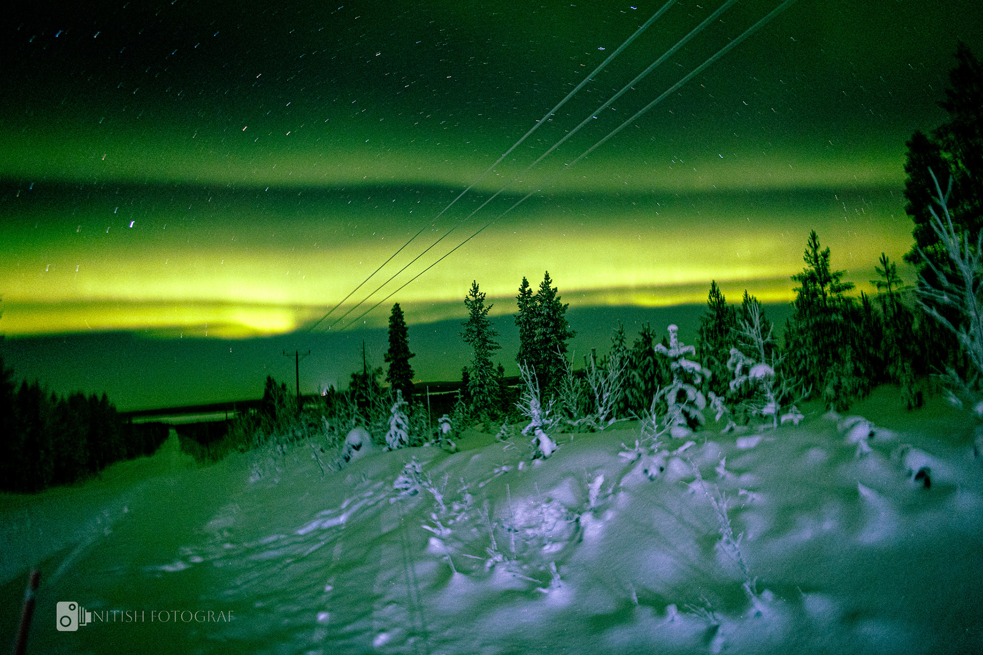 The magical glow of the northern lights shining over a snow-covered expanse