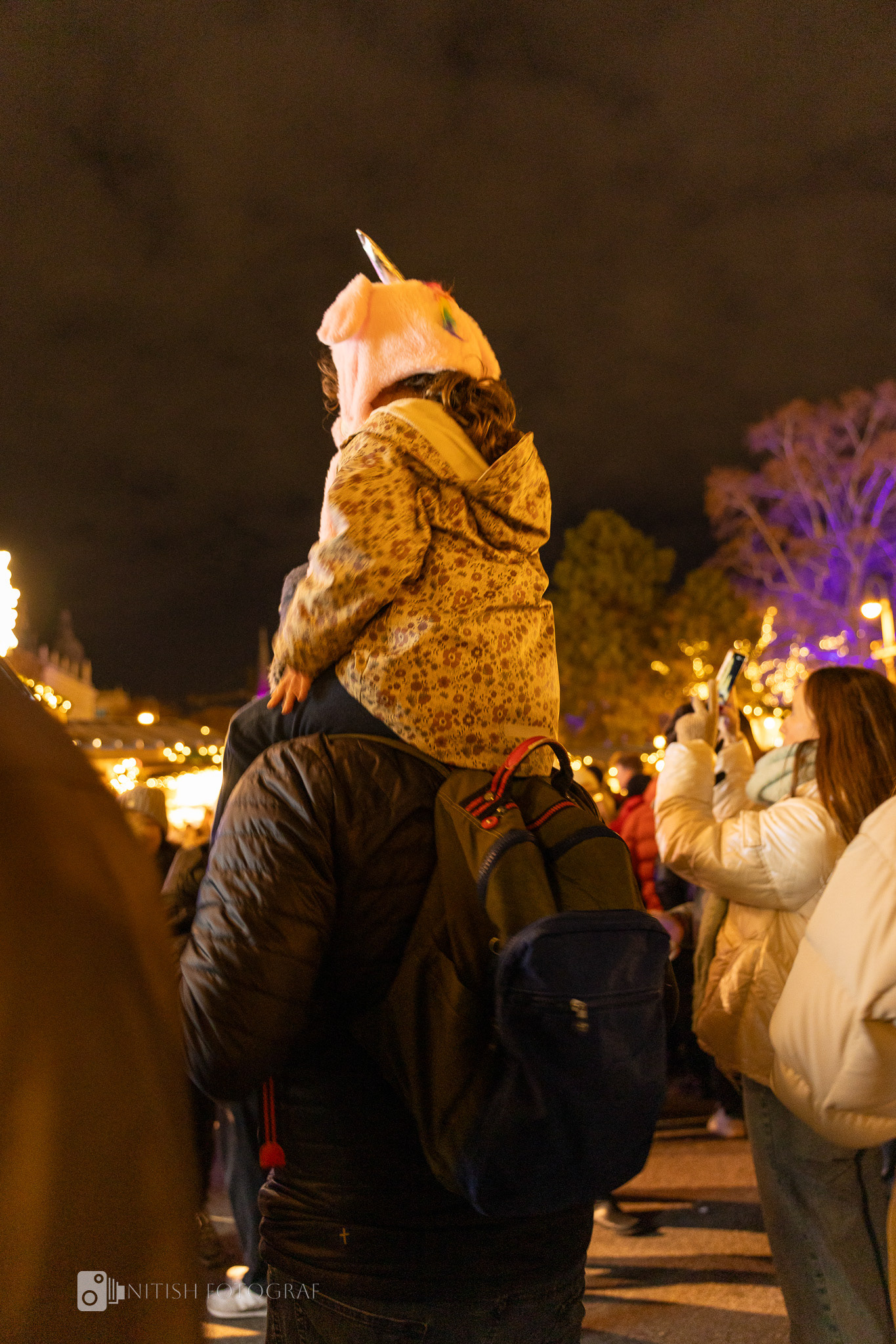Bundled against the cold, yet warmed by the magic of a festive night market