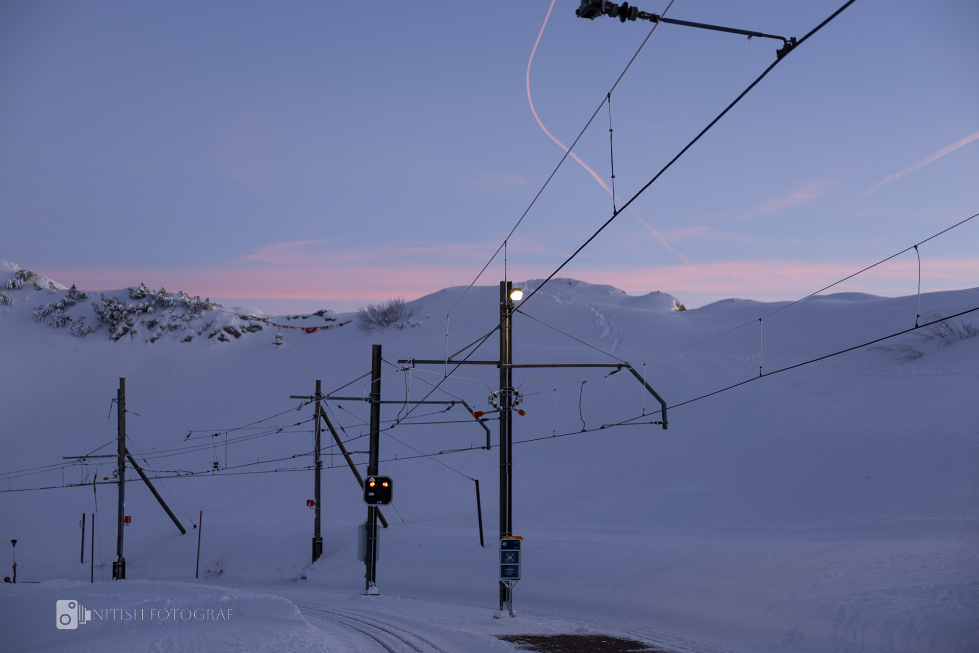 Power lines stretching over a golden sunset blending nature and humanity