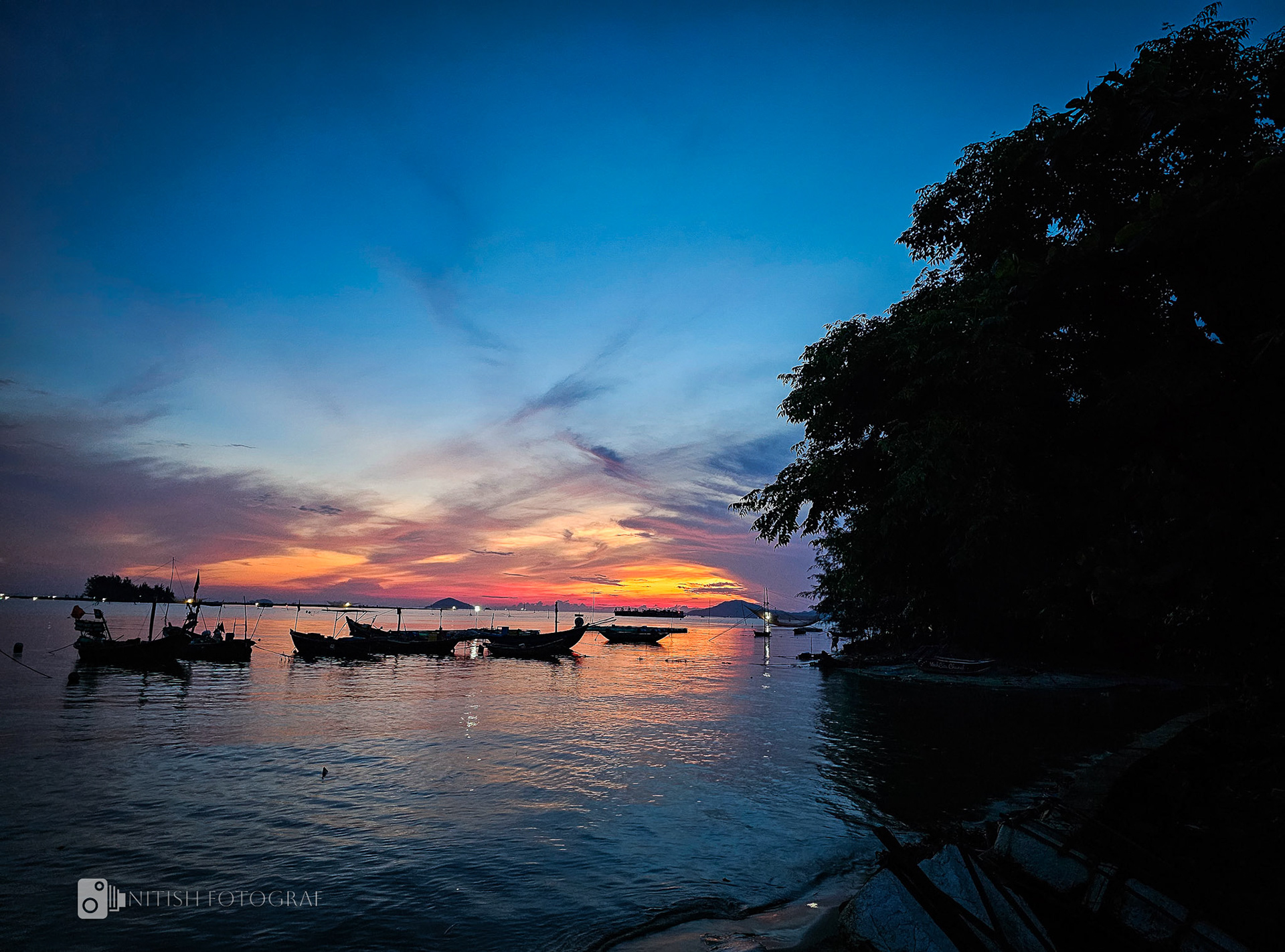 Boats docked in the golden hour reflecting the beauty of a day’s start