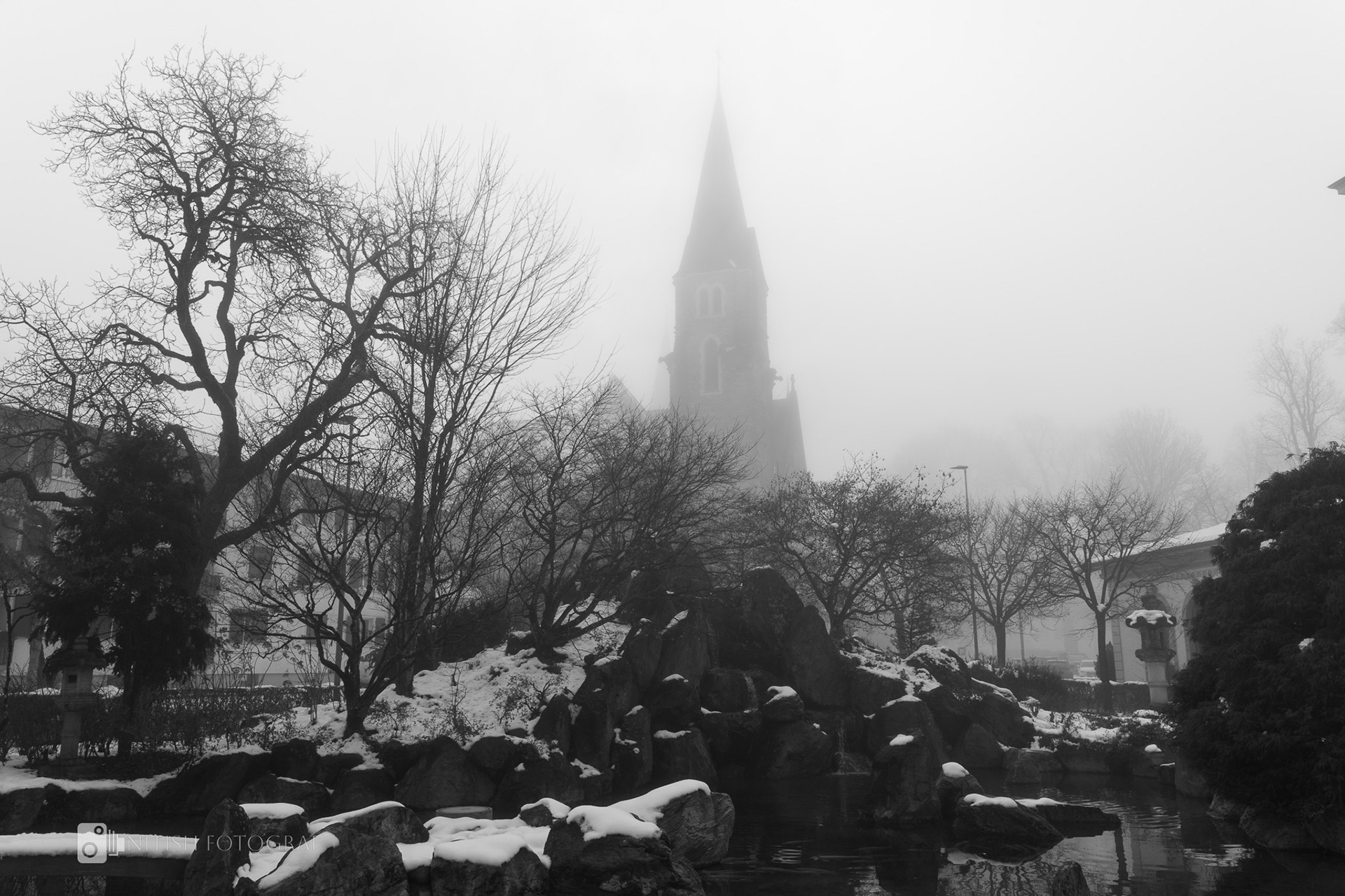 A snow-covered cityscape blending history and nature under a gray sky