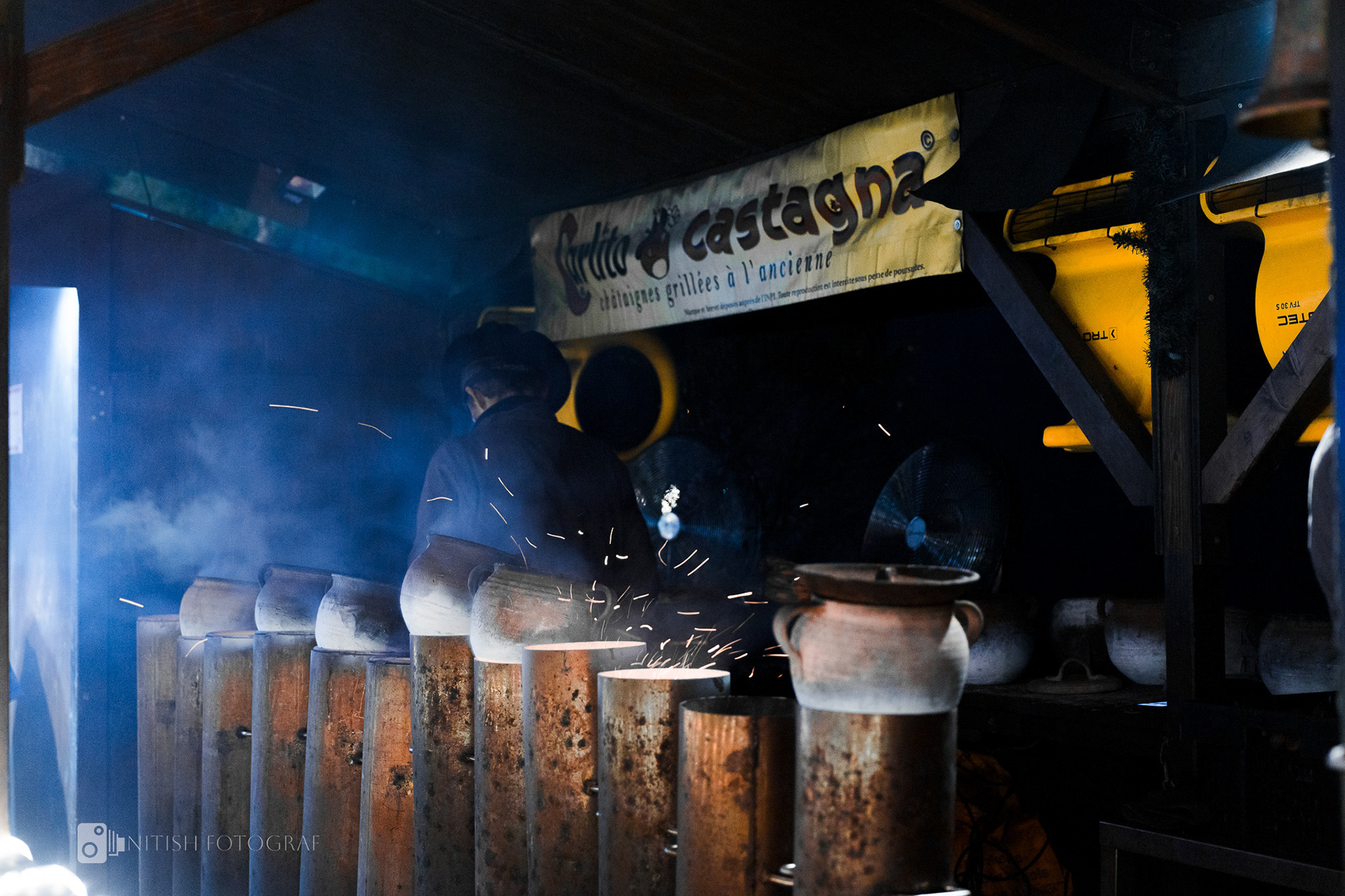 The rising smoke from a food stall hints at the flavors and tales within