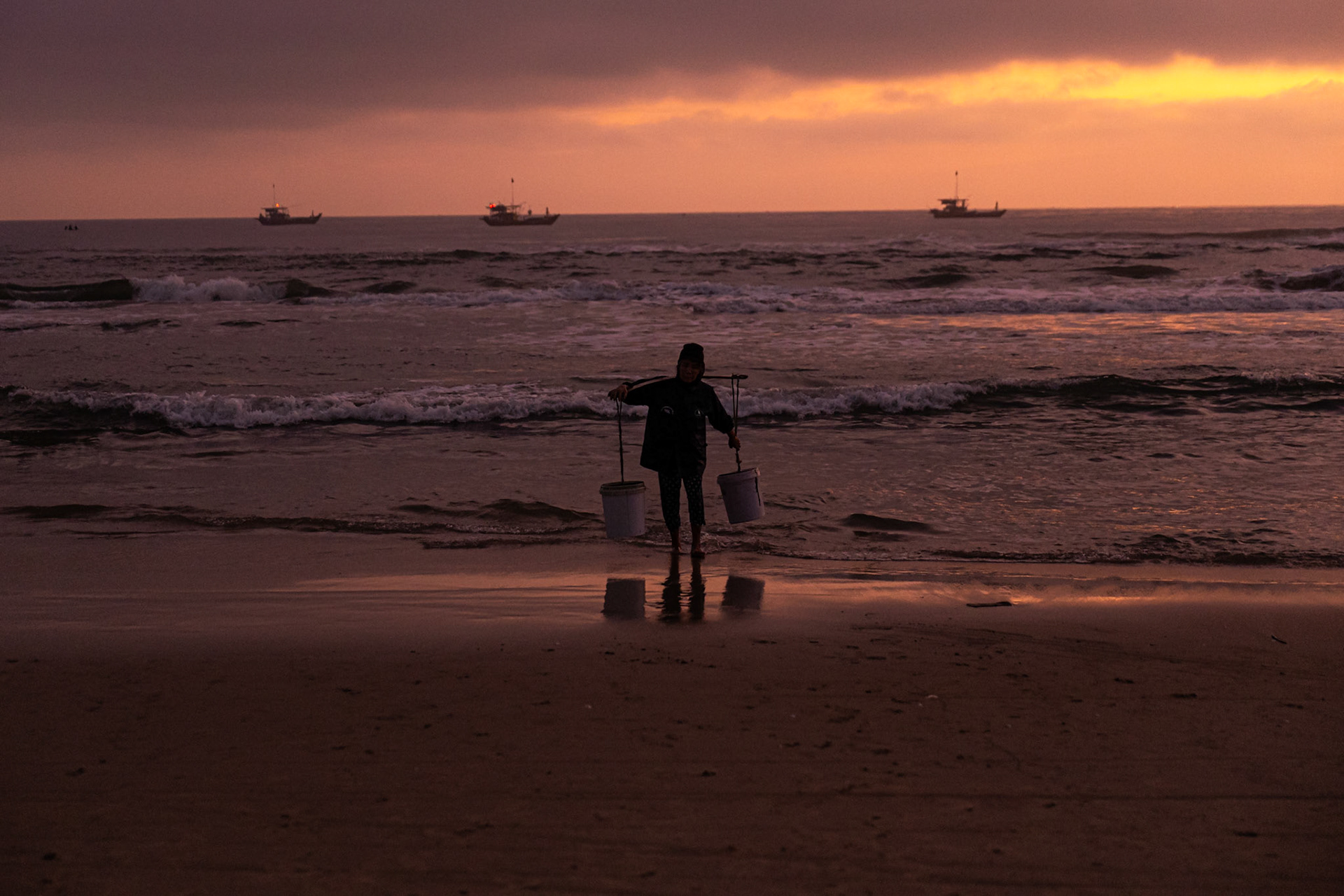 At dawn’s edge, a lone figure carries the weight of a new day