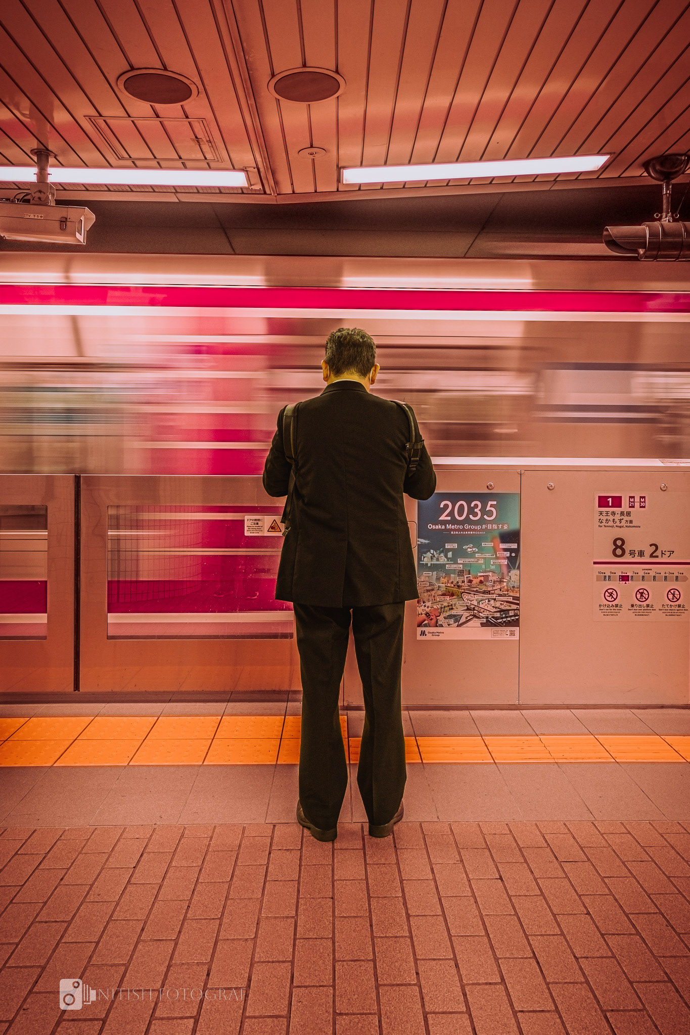 A lone figure in the subway, finding calm in a city that never stops