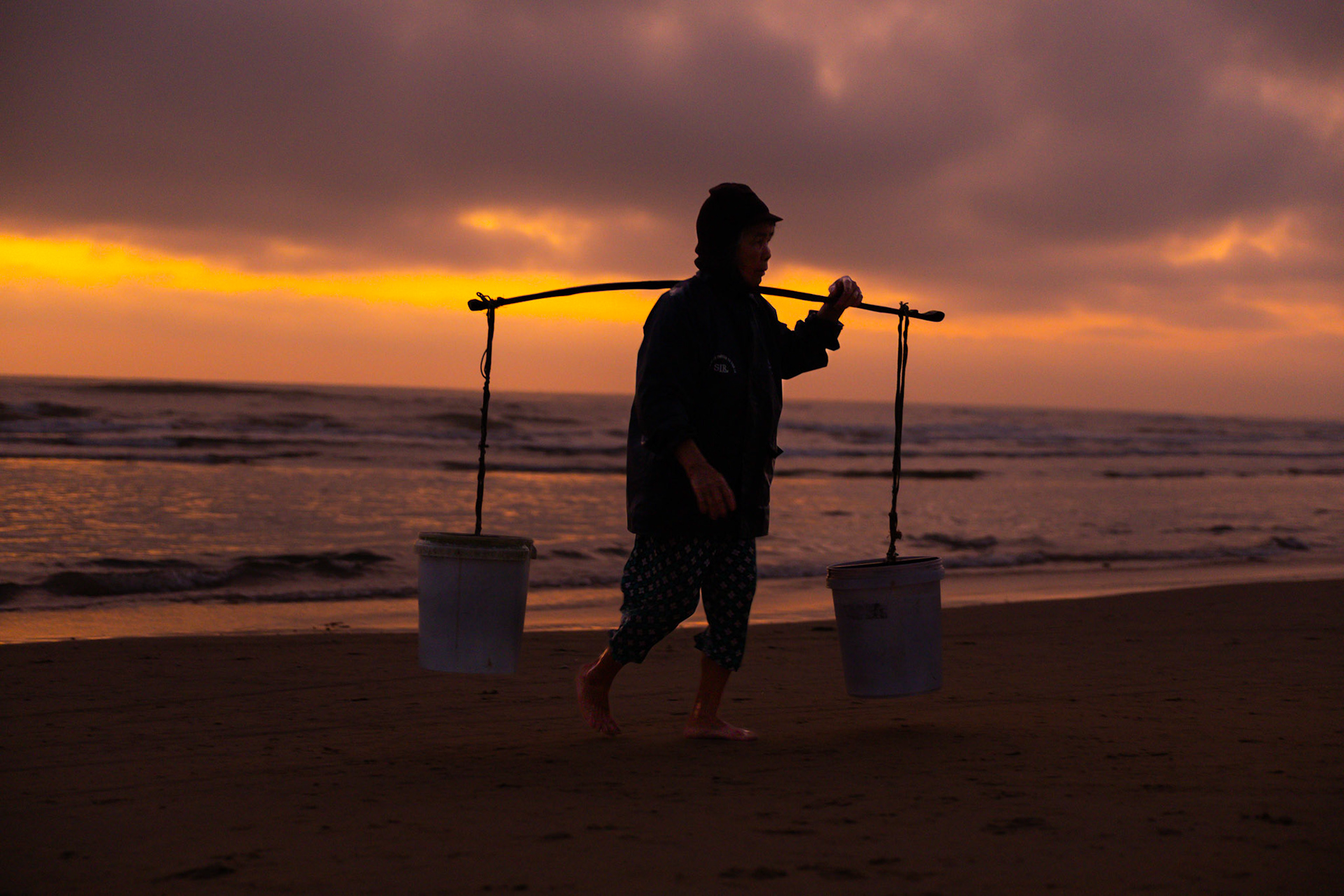 The rhythm of labor, silhouetted against a waking world