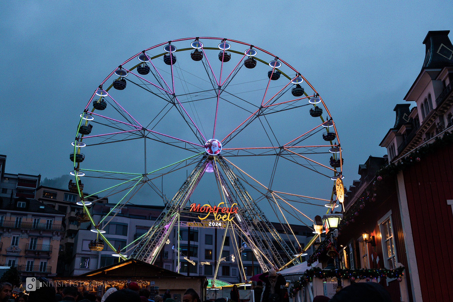 A Ferris wheel spins joy into the night, lighting up the festive air