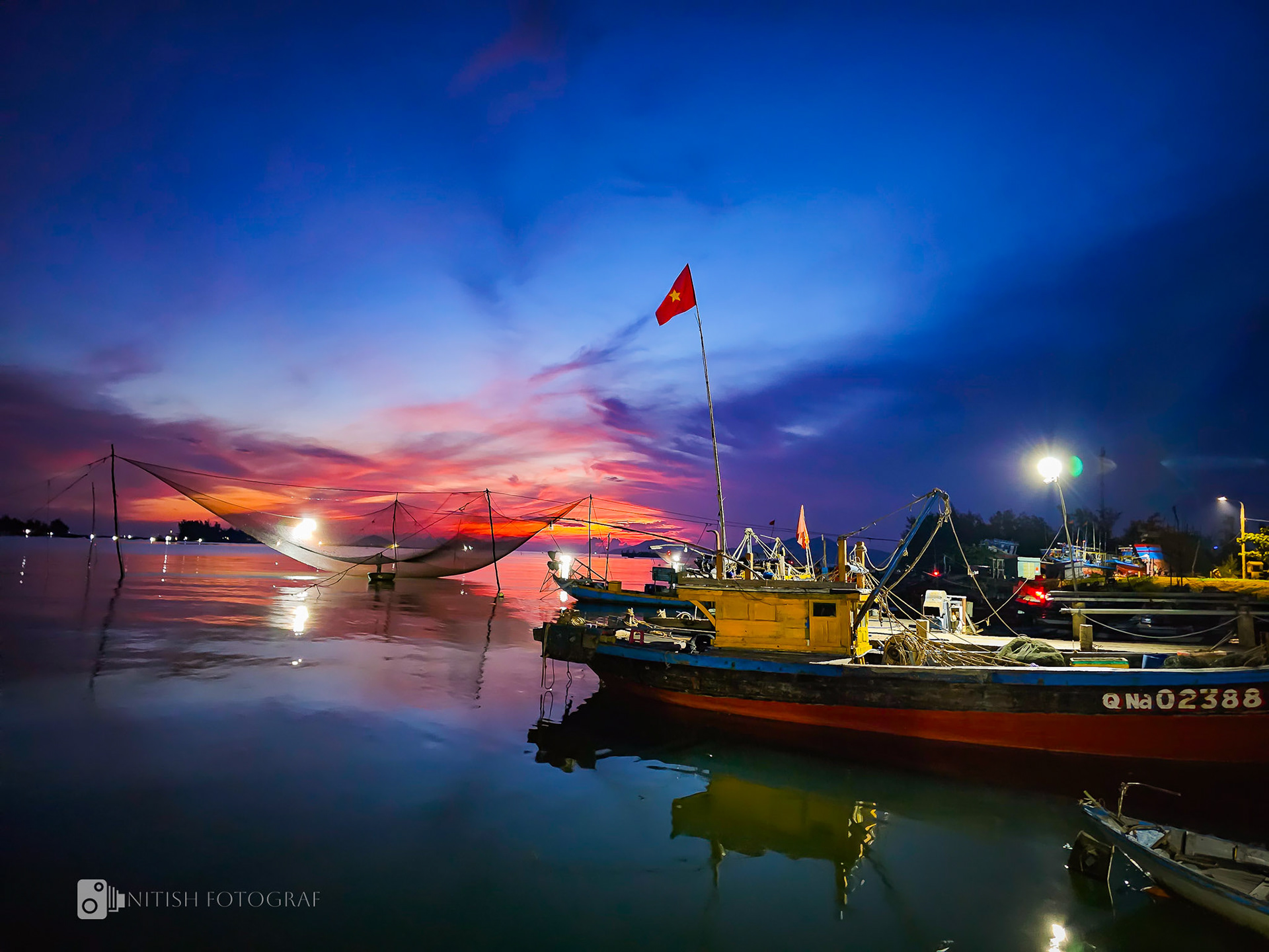 A stunning sunrise painting the harbor in hues of red and orange