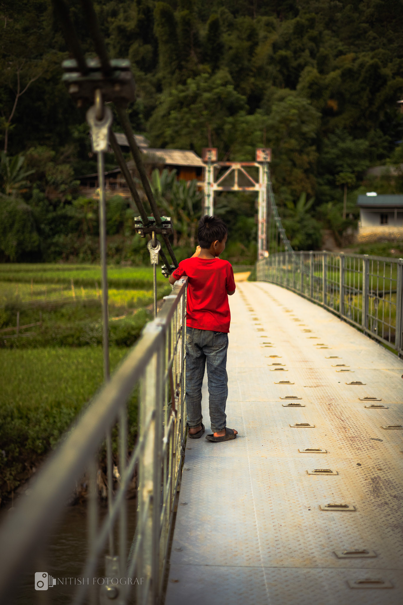 Curious eyes and a quiet moment – discovering the world from the edge of a bridge.