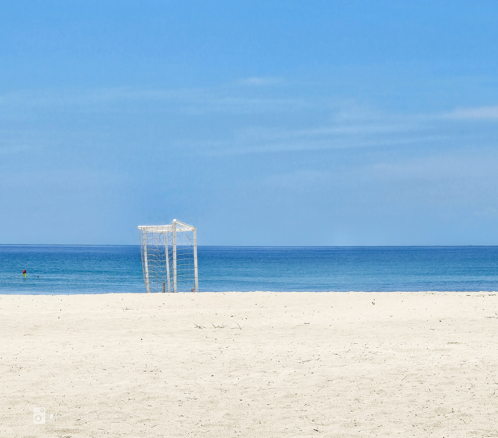 A goalpost stand standing tall on a pristine untouched beach