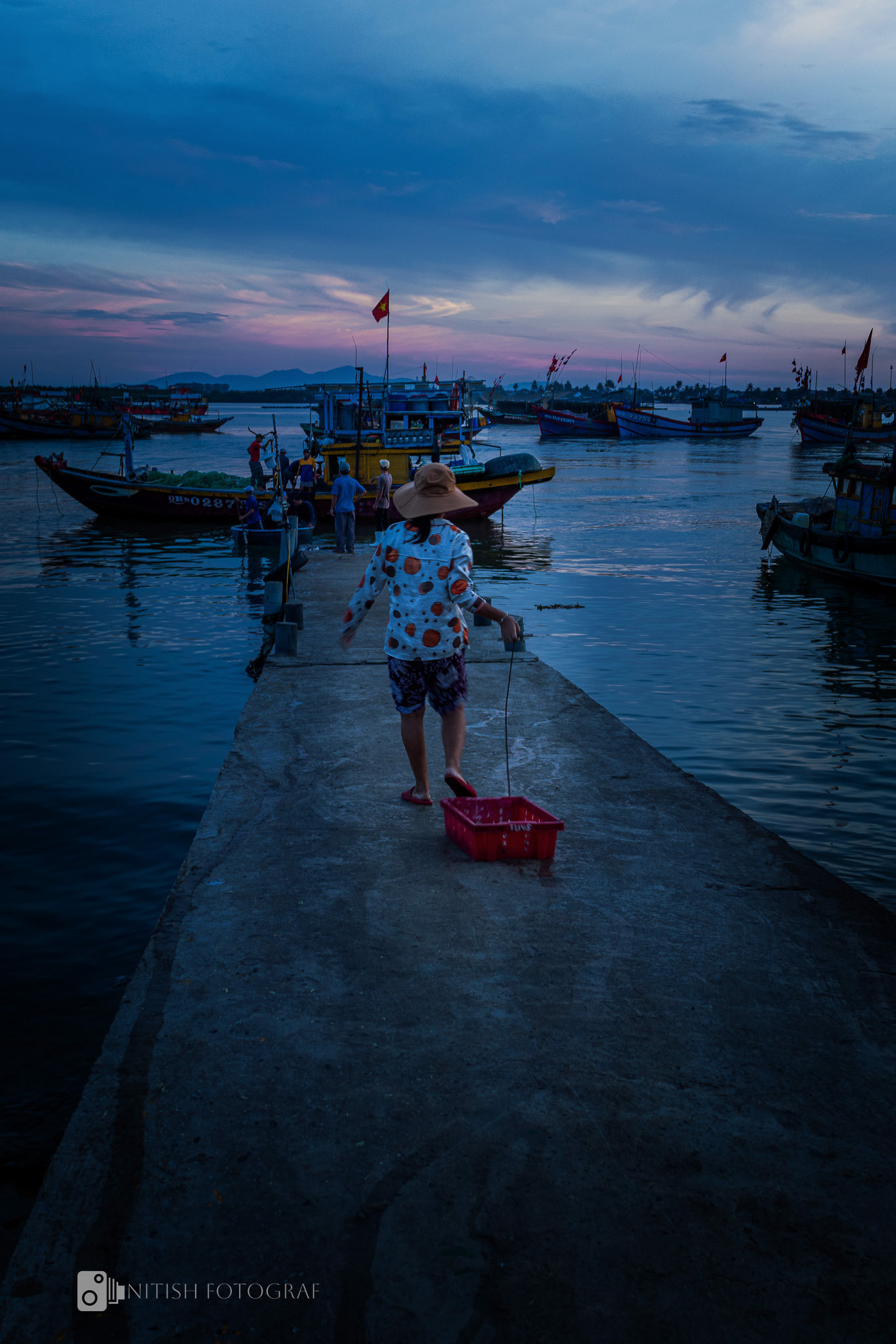 Morning hues and daily routines – a serene moment by the harbor.